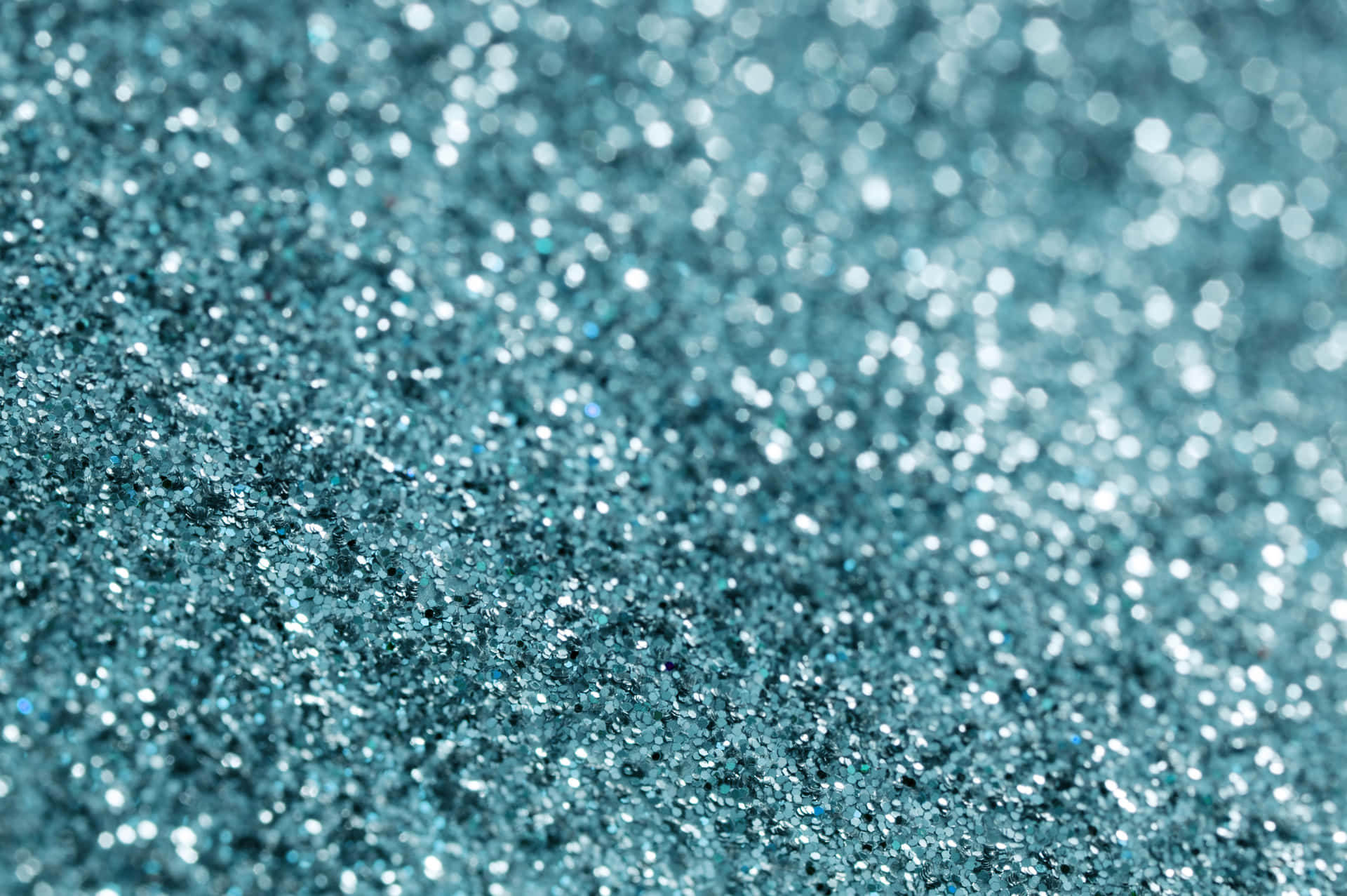 A vibrant teal glitter background.