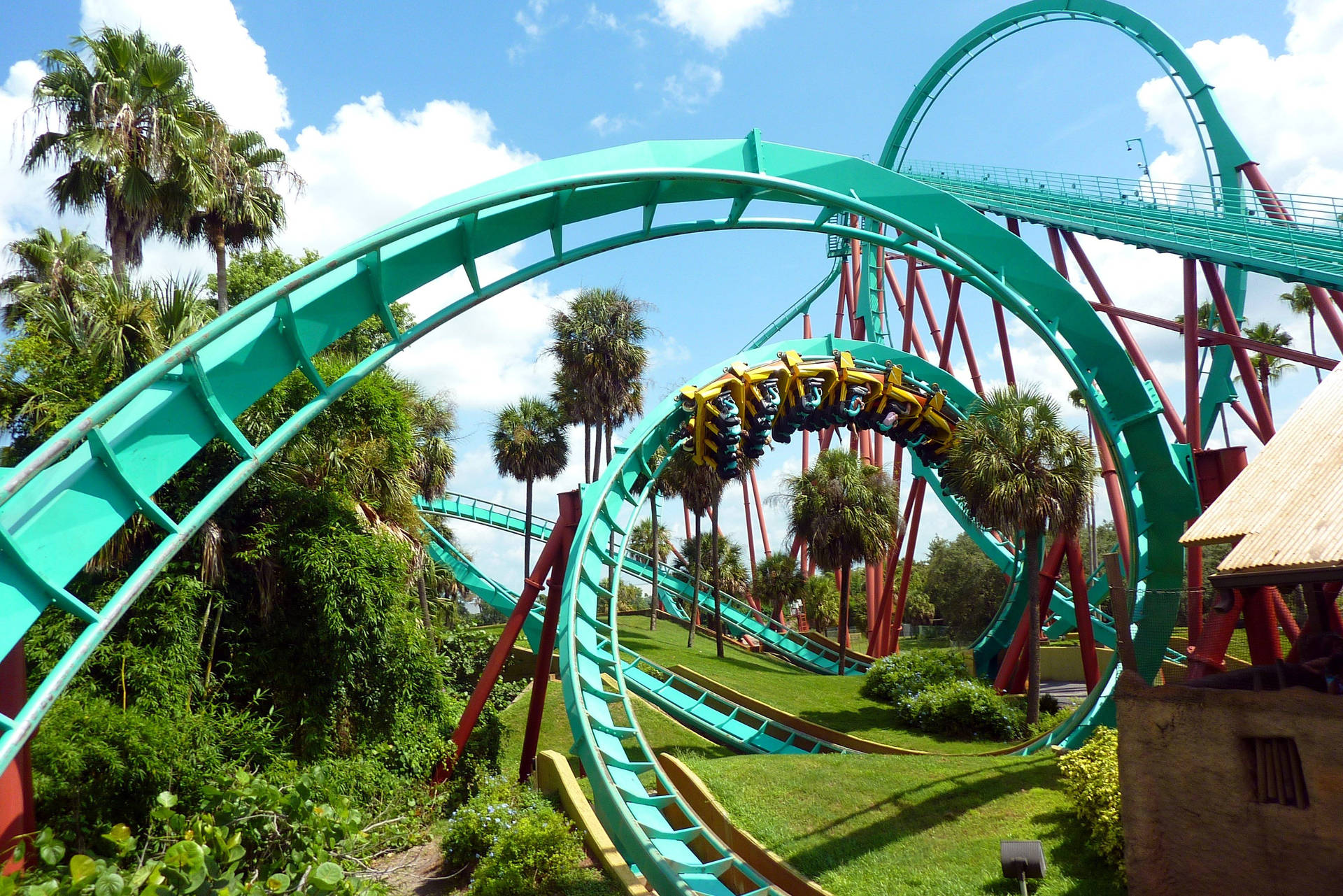 Exciting ride on a teal-colored roller coaster Wallpaper