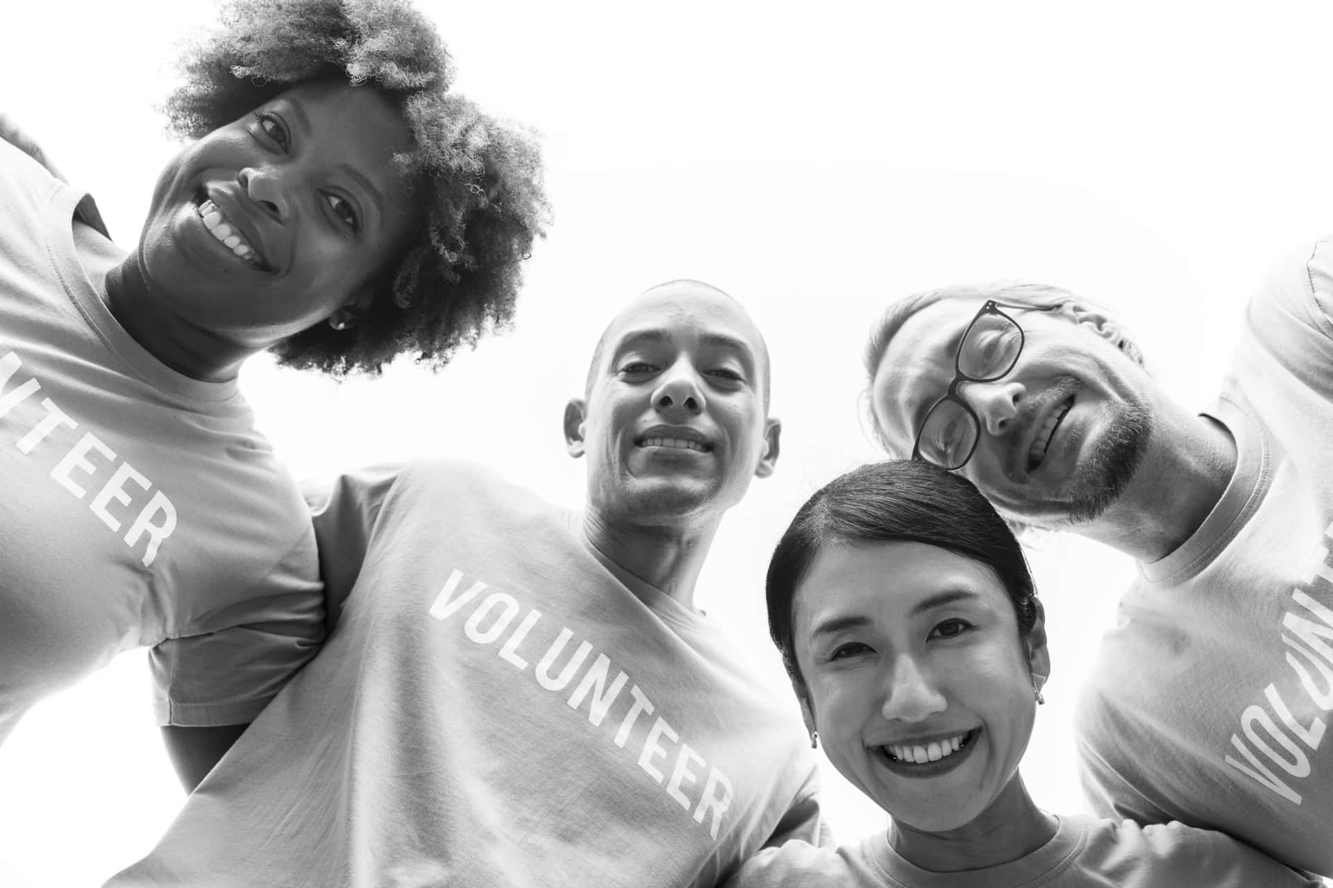 A Group Of People In T - Shirts With The Word Volunteer