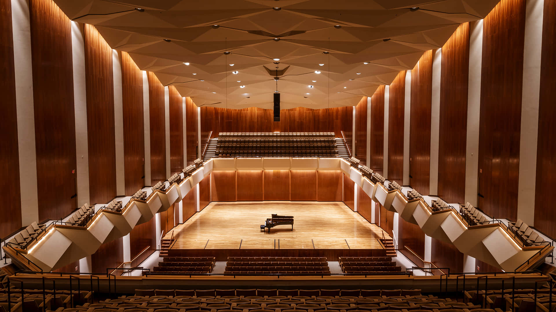 A Large Auditorium With Wooden Walls And A Piano
