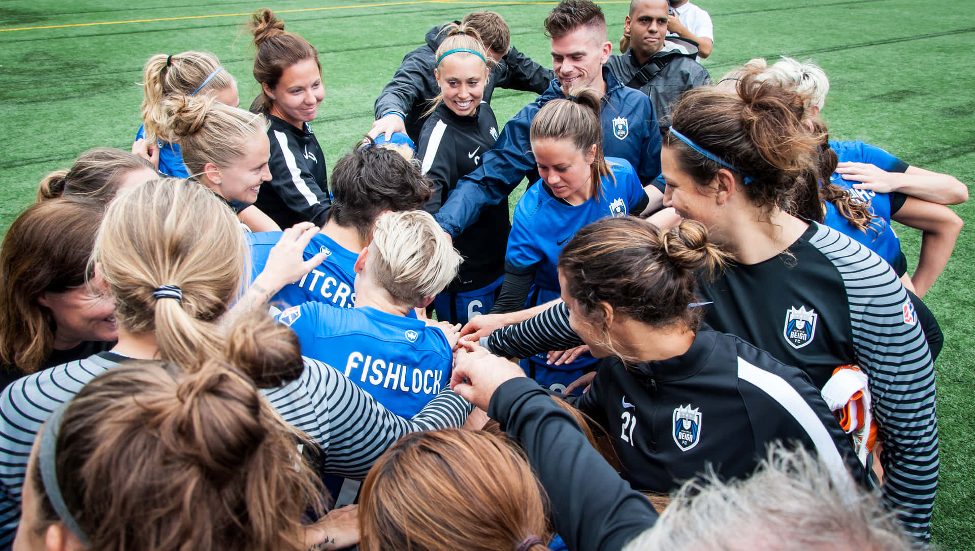 A Group Of Women Soccer Players Huddled Together