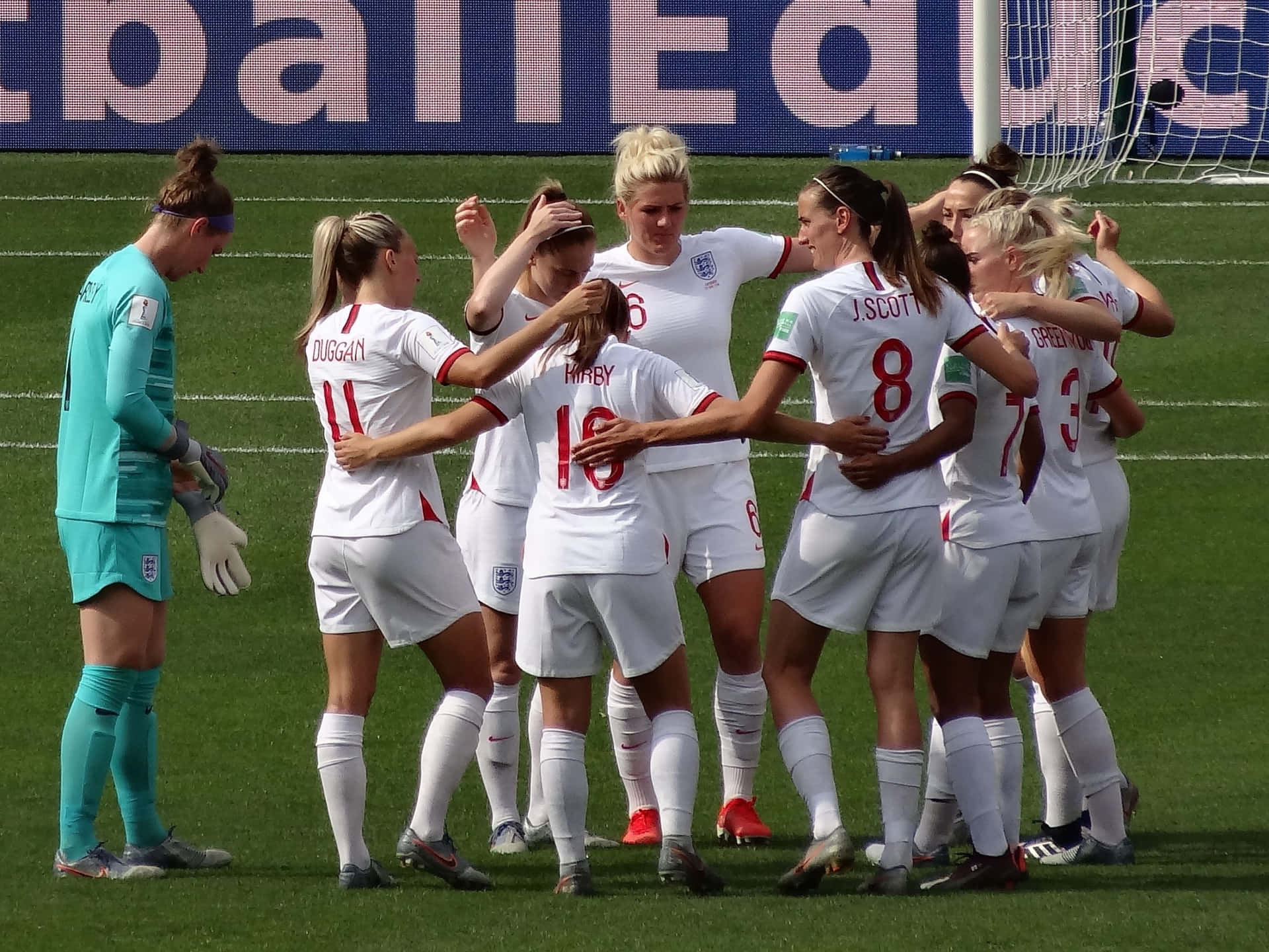 A Group Of Women Soccer Players Huddle Together