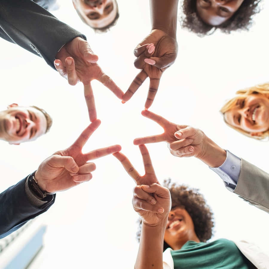 A Group Of People Making A Star With Their Hands Wallpaper