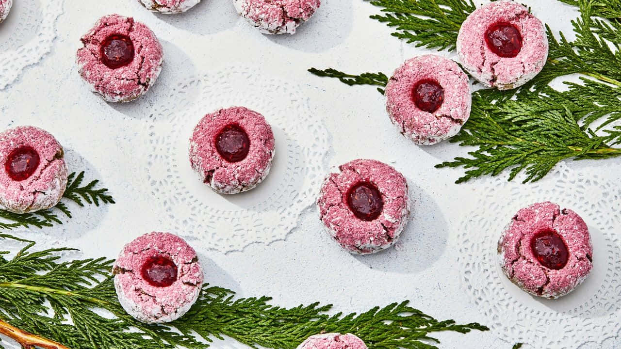 A Plate Of Pink And Green Cookies With A Pine Tree