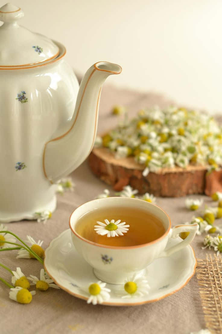 A Teapot With A Cup Of Tea And A Cup Of Chamomile