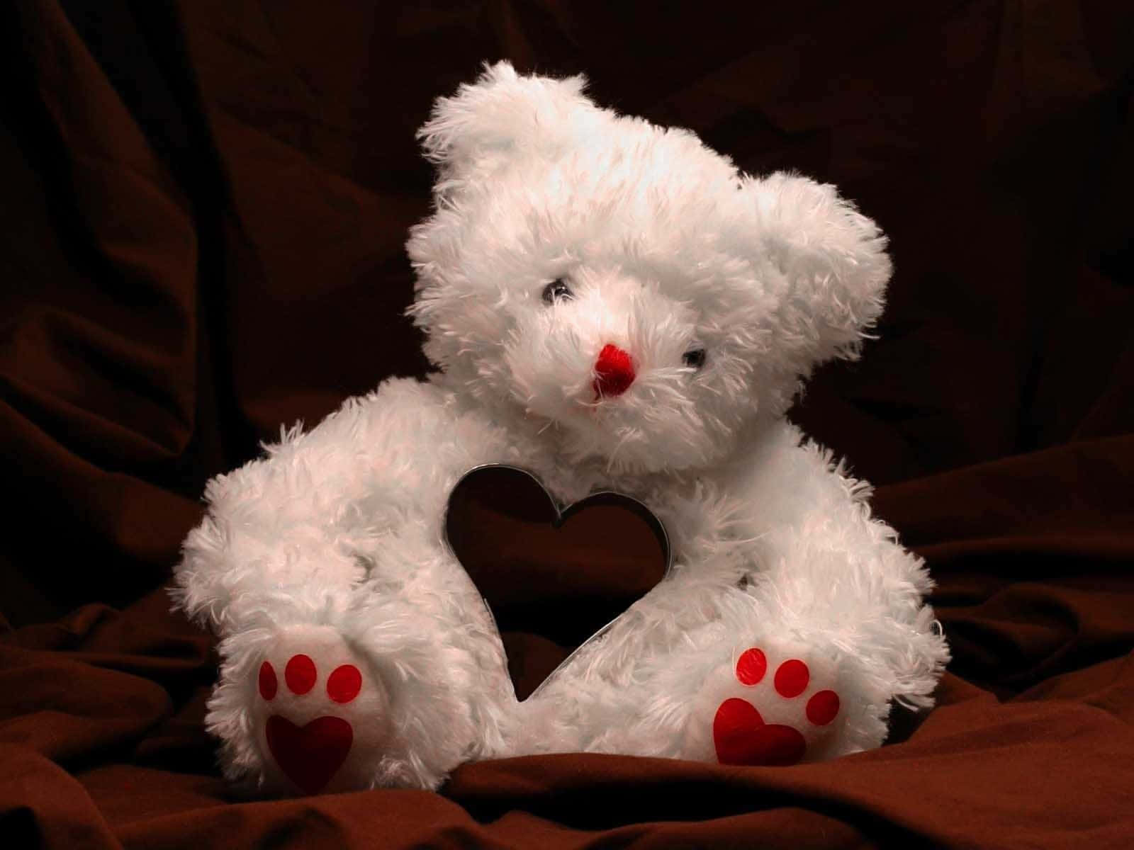 A cutesy teddy bear is snuggled up and waiting for a hug.