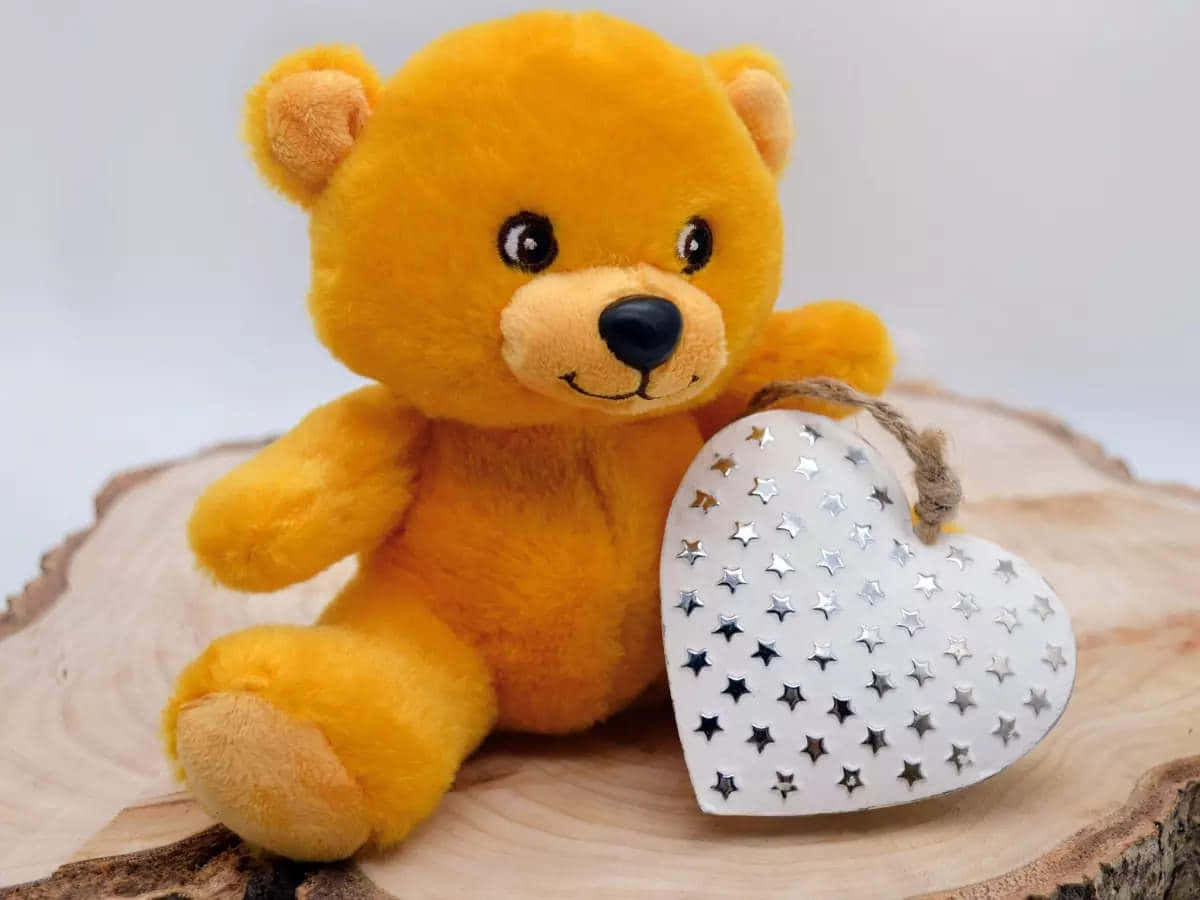 A Teddy Bear With A Heart Shaped Star On A Log