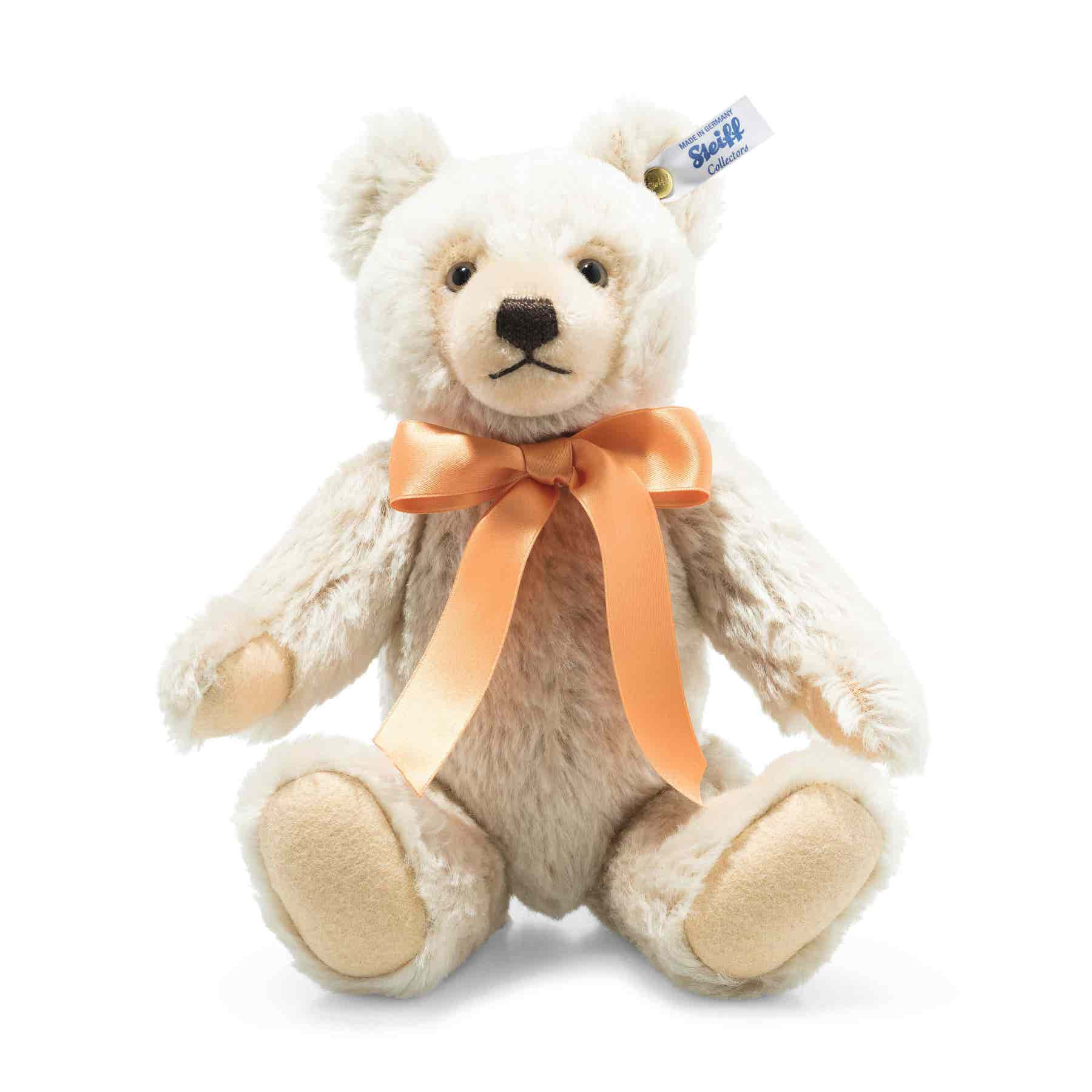 A White Teddy Bear With An Orange Bow