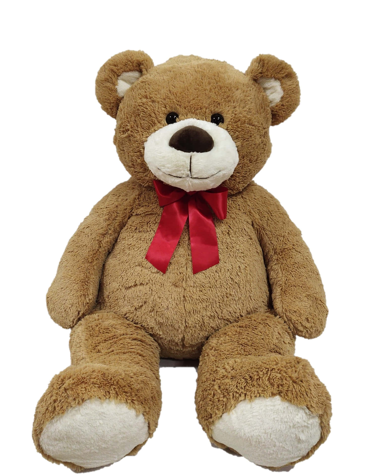 A Large Brown Teddy Bear With A Red Bow