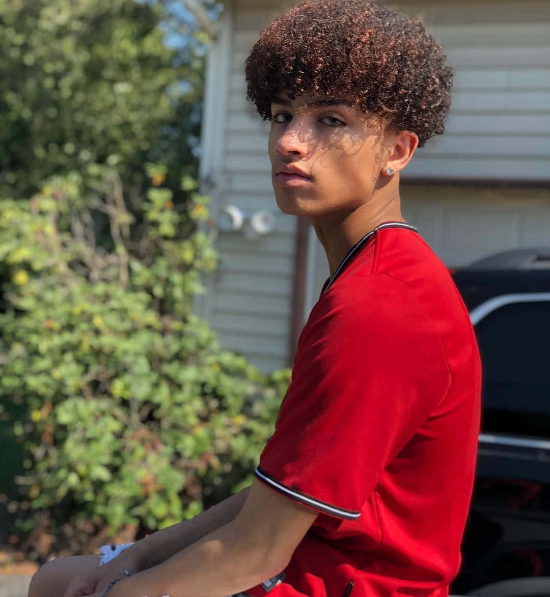 Teen Boy Curly Hair Outdoors Wallpaper