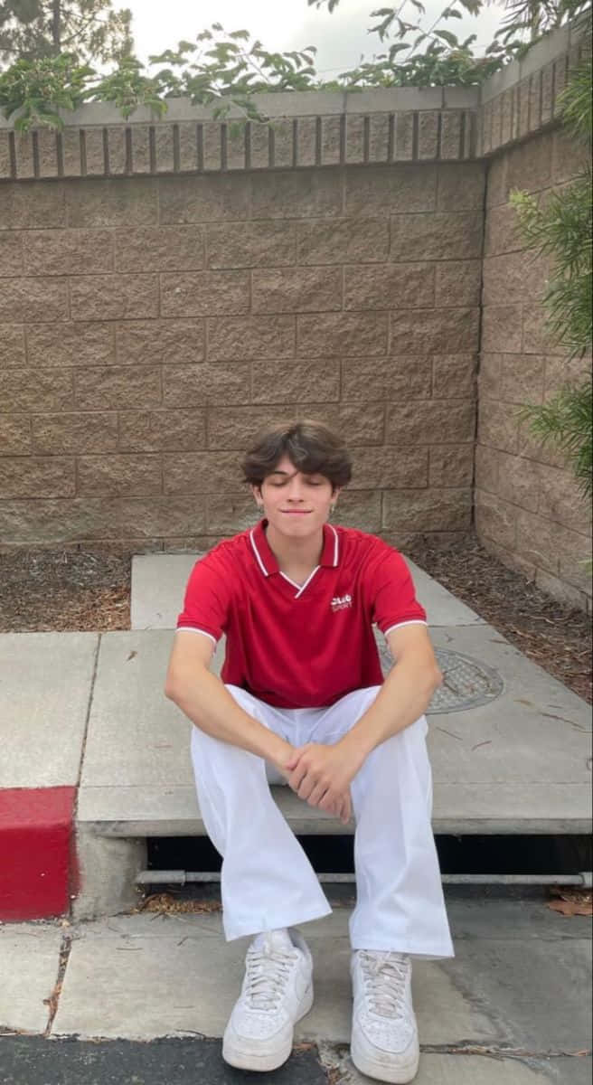 Teen Boy Sitting Outdoor Red Shirt Wallpaper