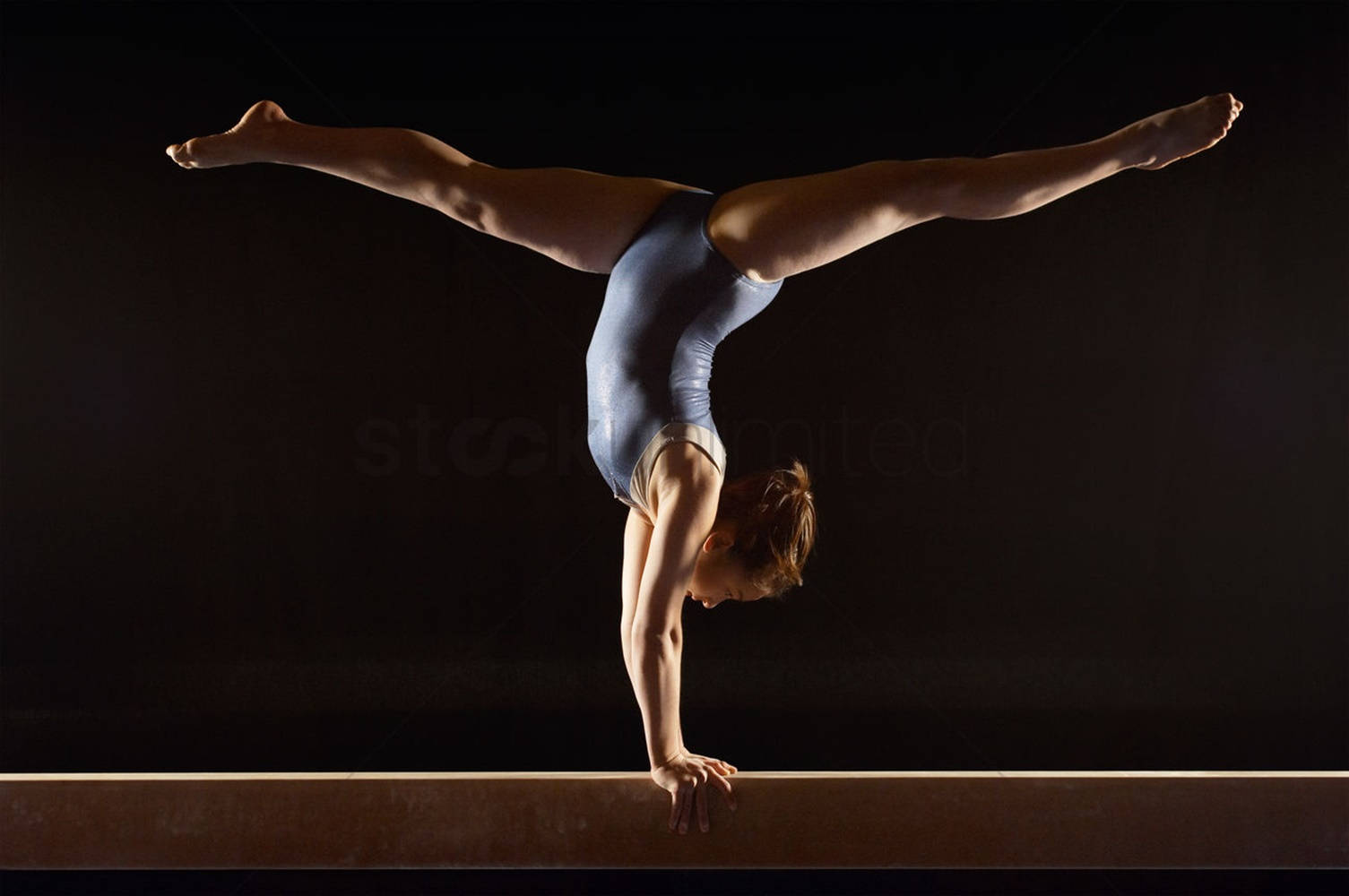 Teen Girl Handstand On Balance Beam Wallpaper