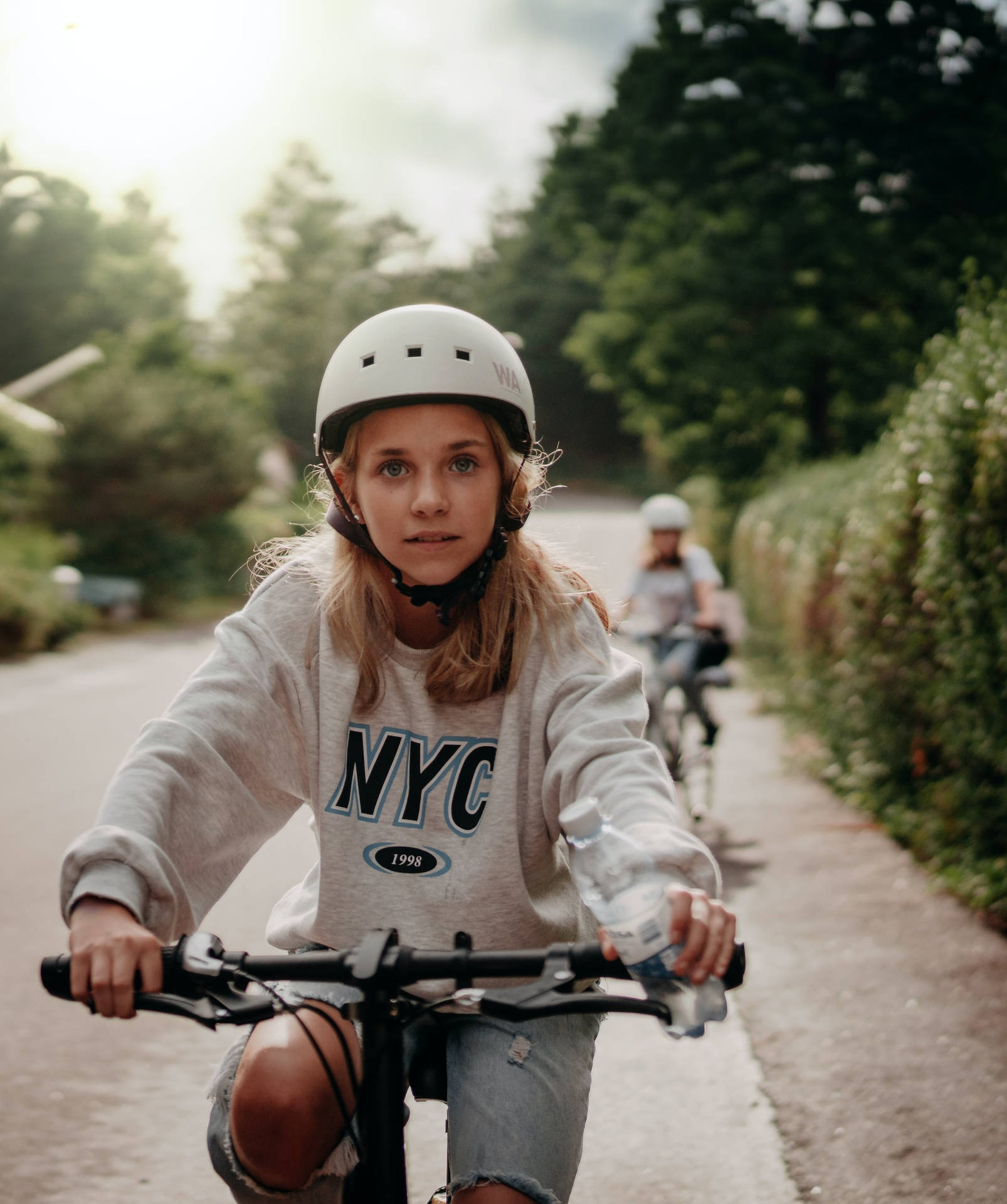 Teenage Blonde Girl Riding Bicycle Wallpaper