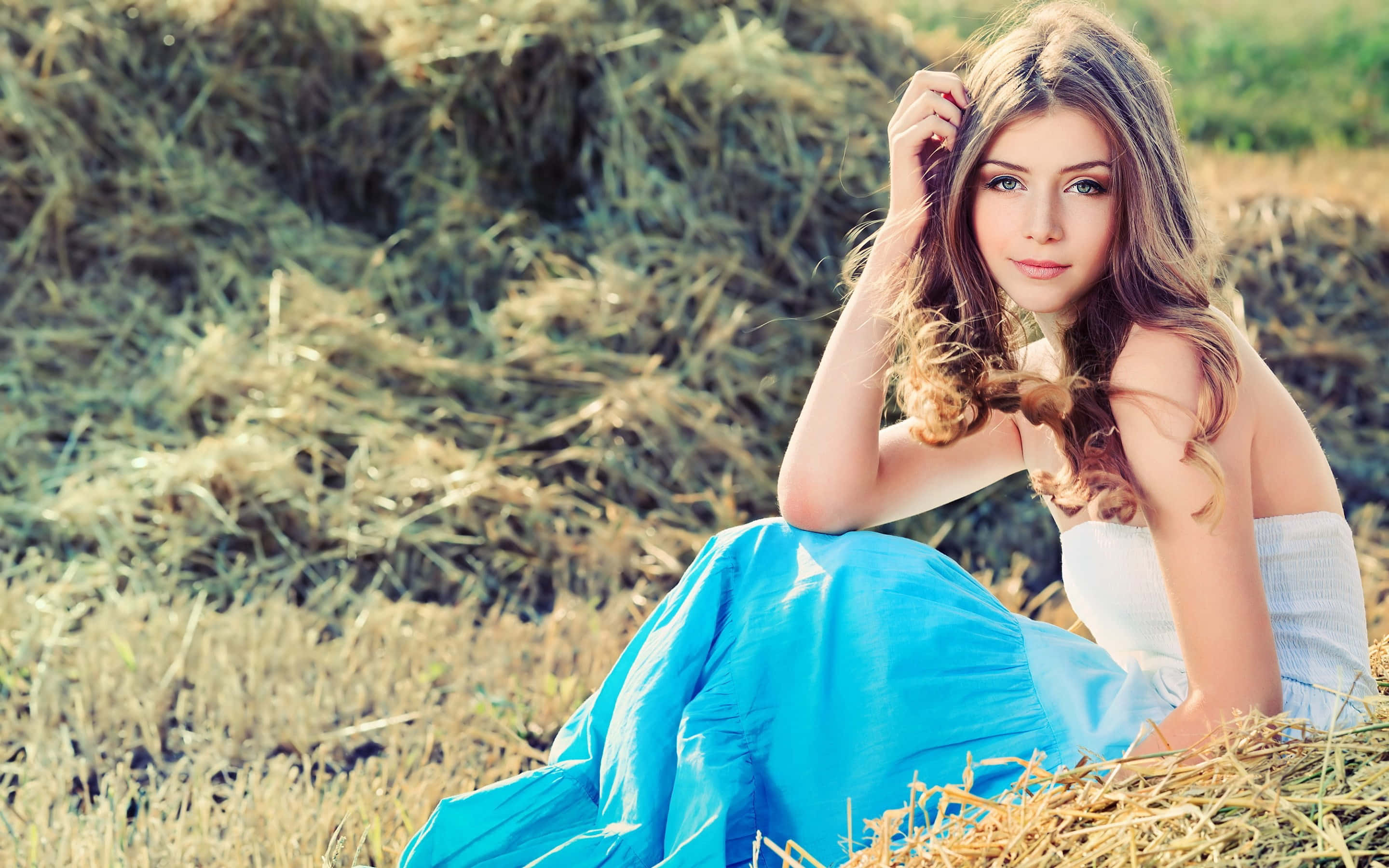 Teenage Girl Sitting In Green Hay Pictures