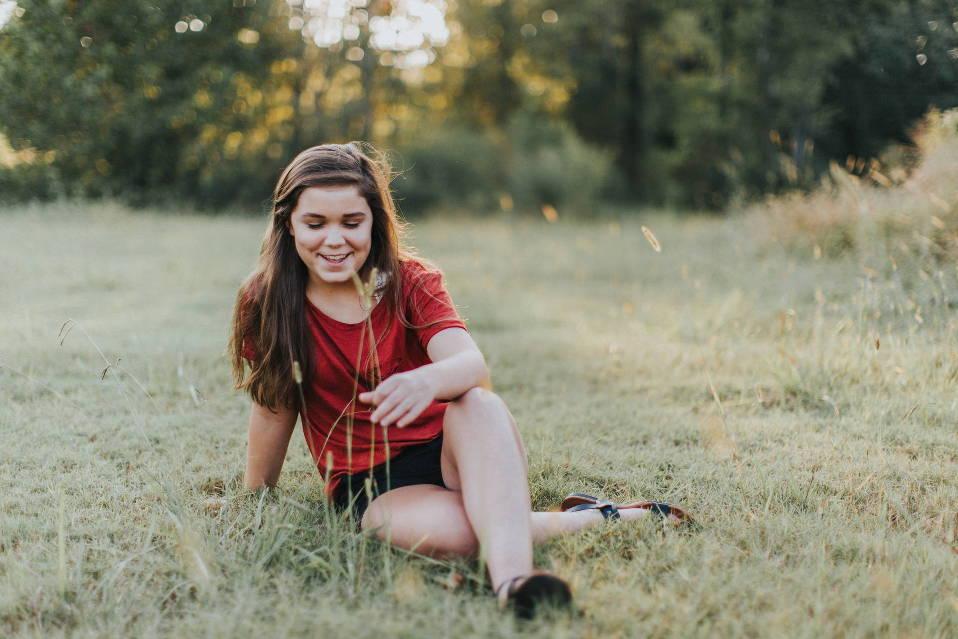 Teenage Girl Sitting On The Grass Wallpaper