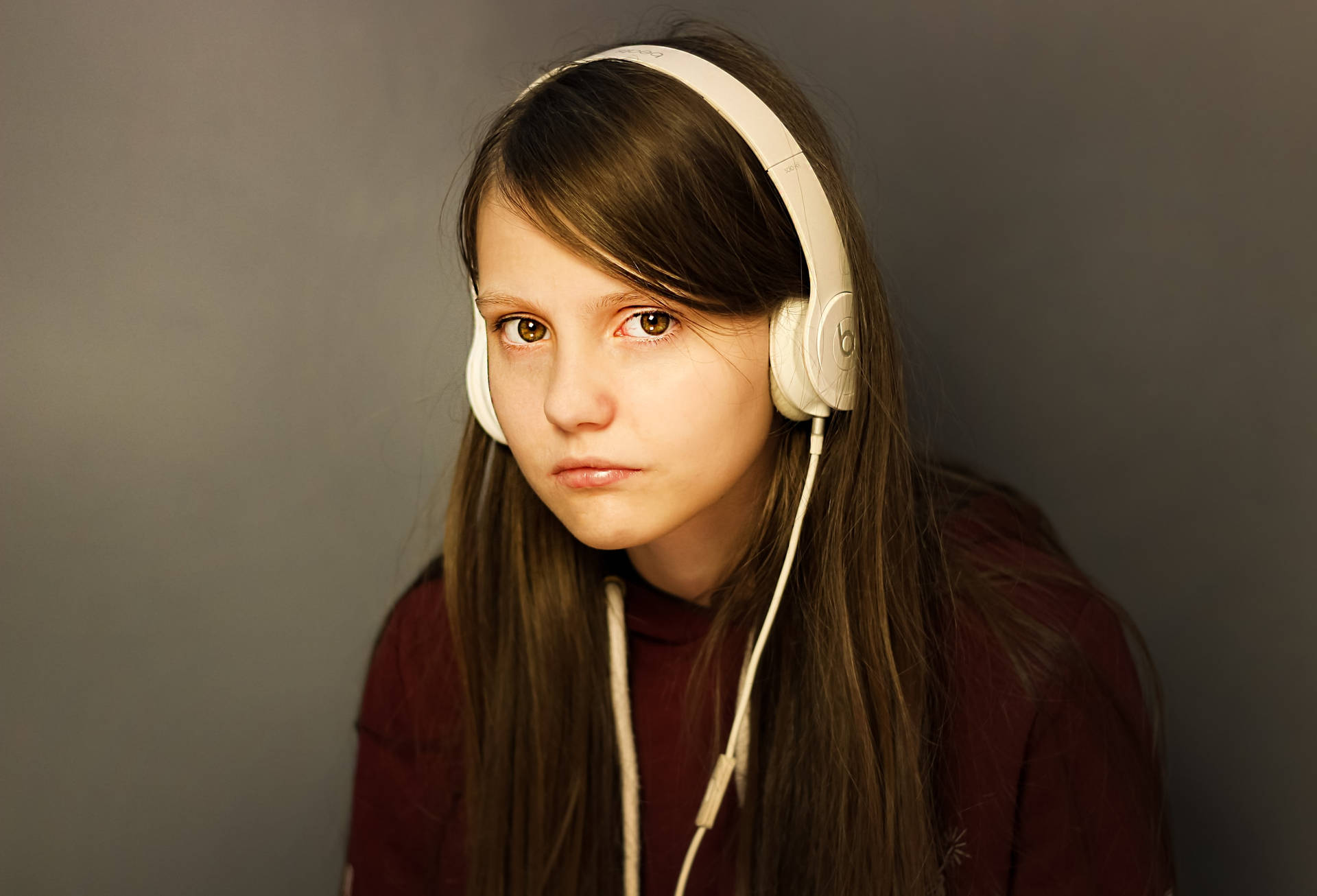 Teenage Girl White Headset And Maroon Sweater Wallpaper