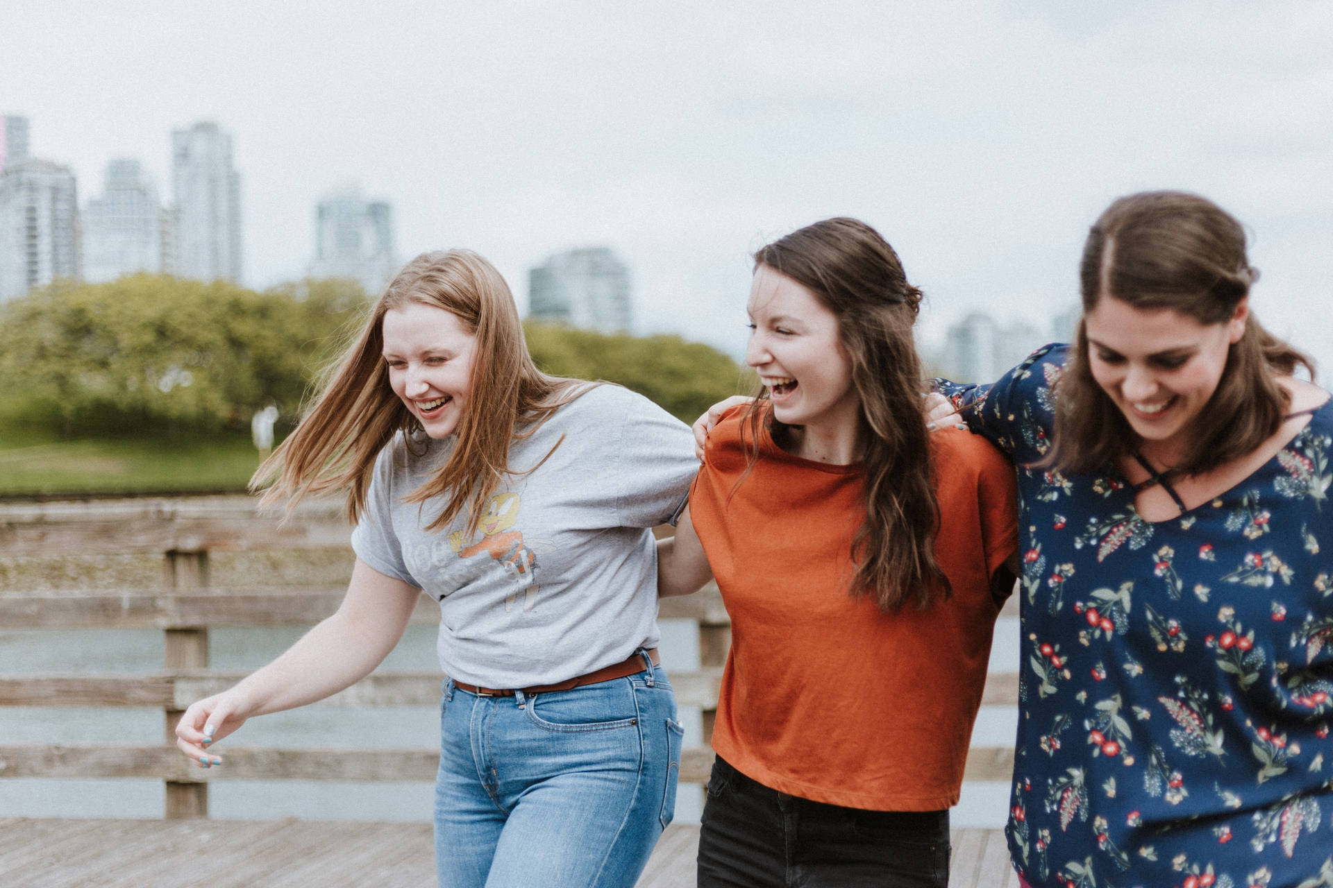 Teenage Three Girls Walking And Laughing Wallpaper