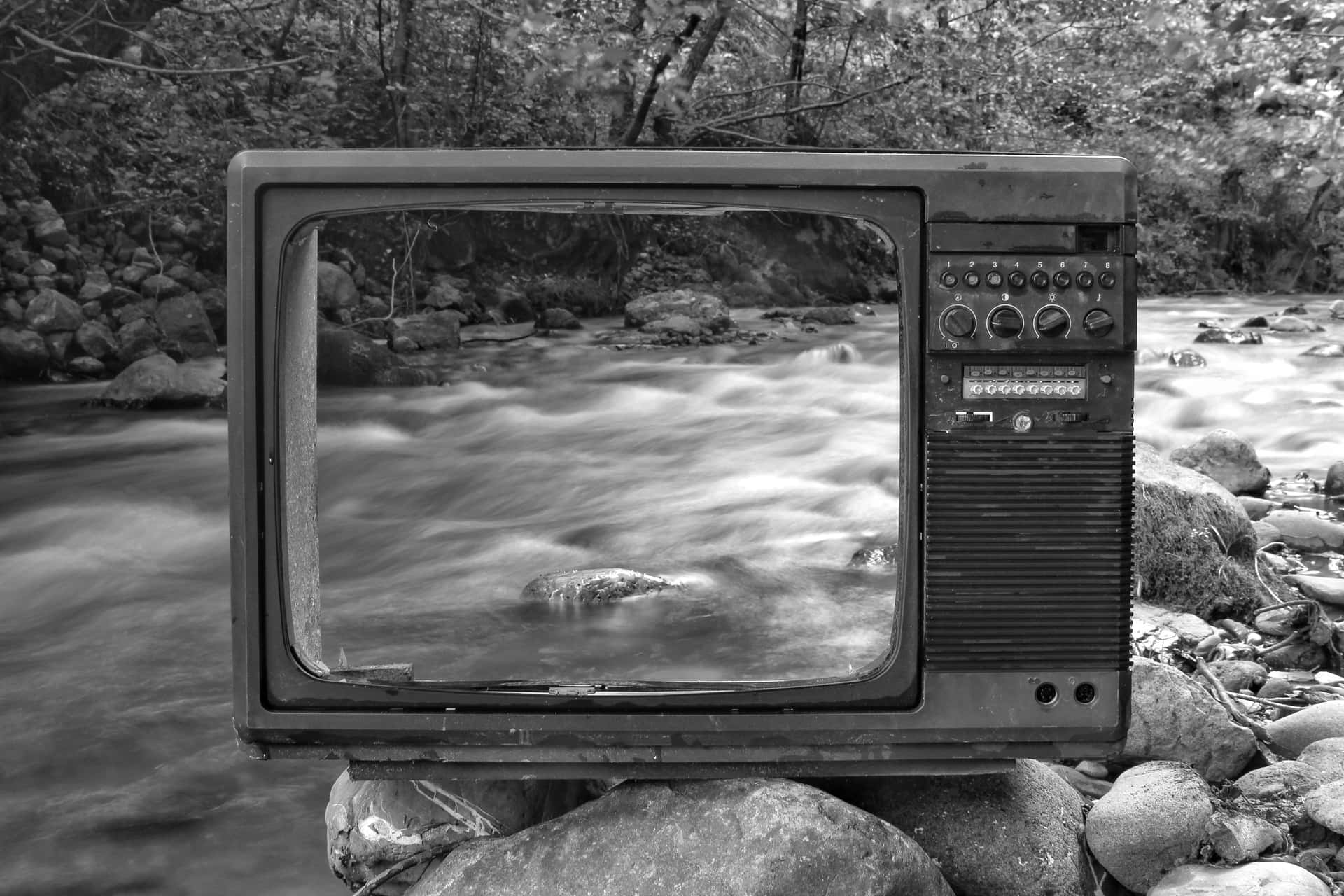 A Television Sitting On Rocks