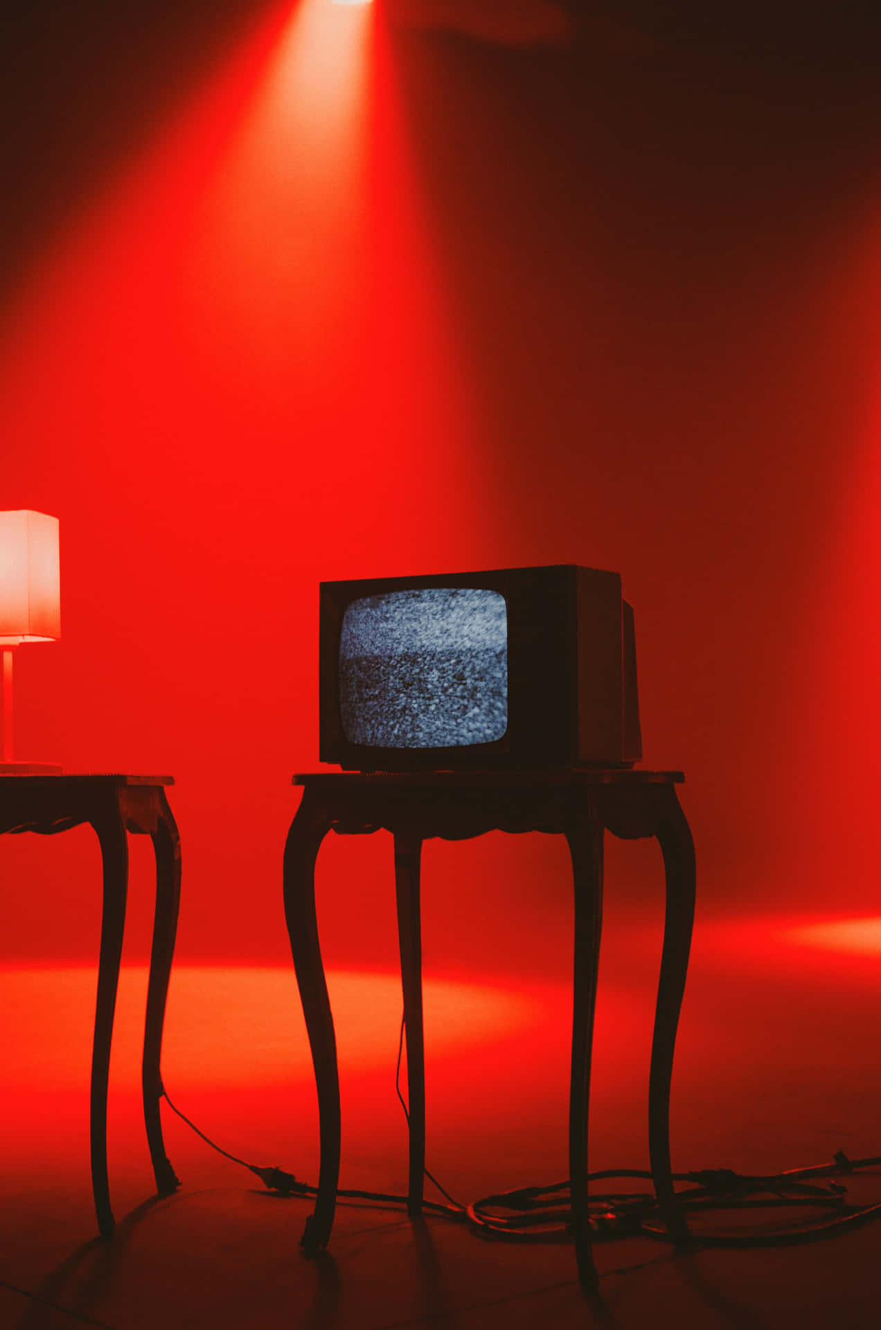 A Television And A Lamp On A Table Wallpaper