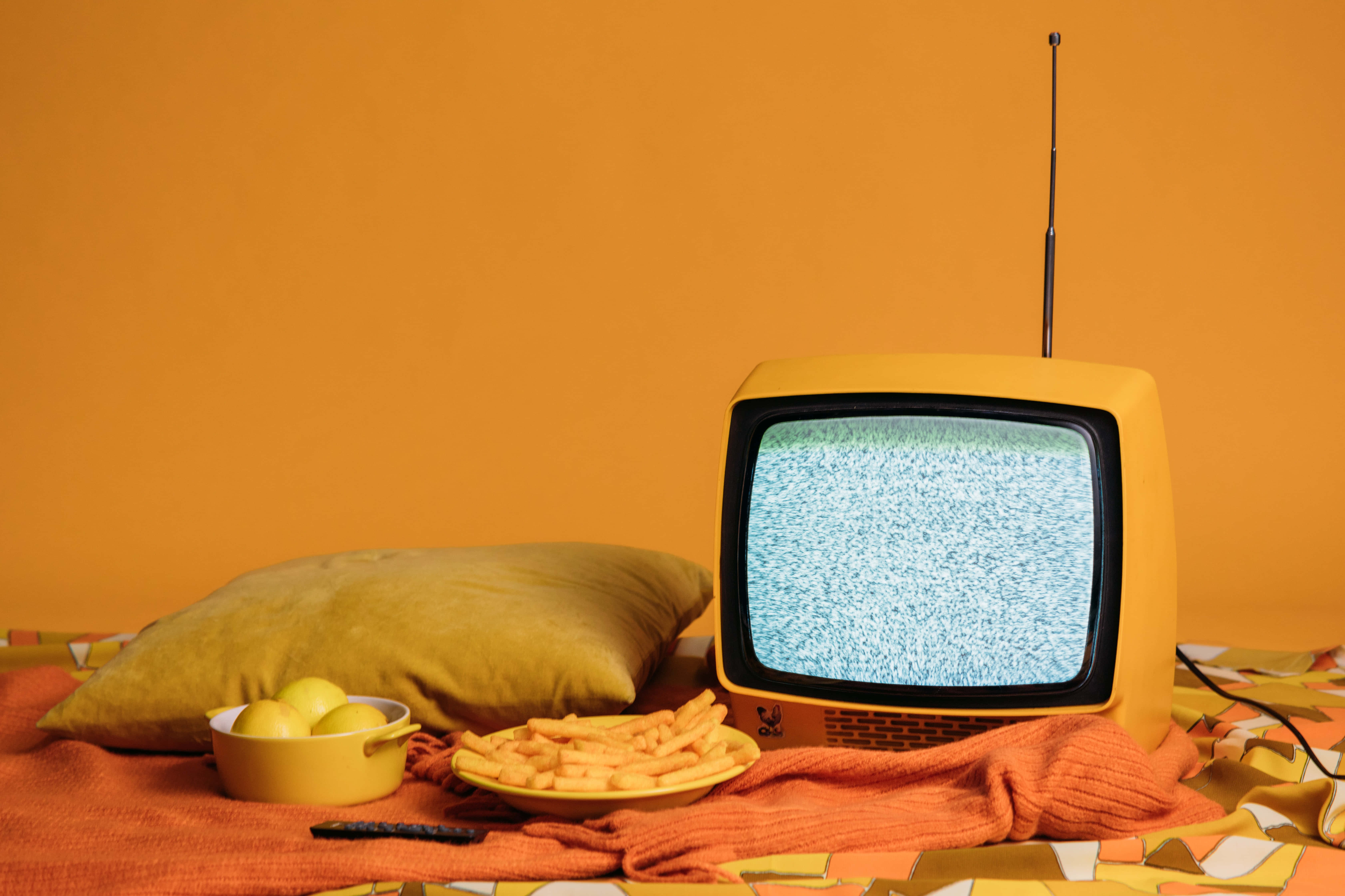A Yellow Tv On A Yellow Blanket