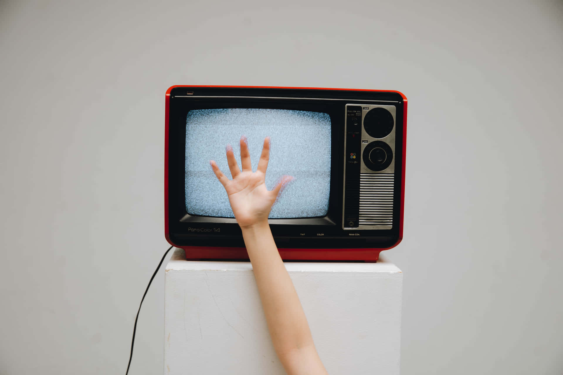 A Woman Reaching Out To A Television Wallpaper