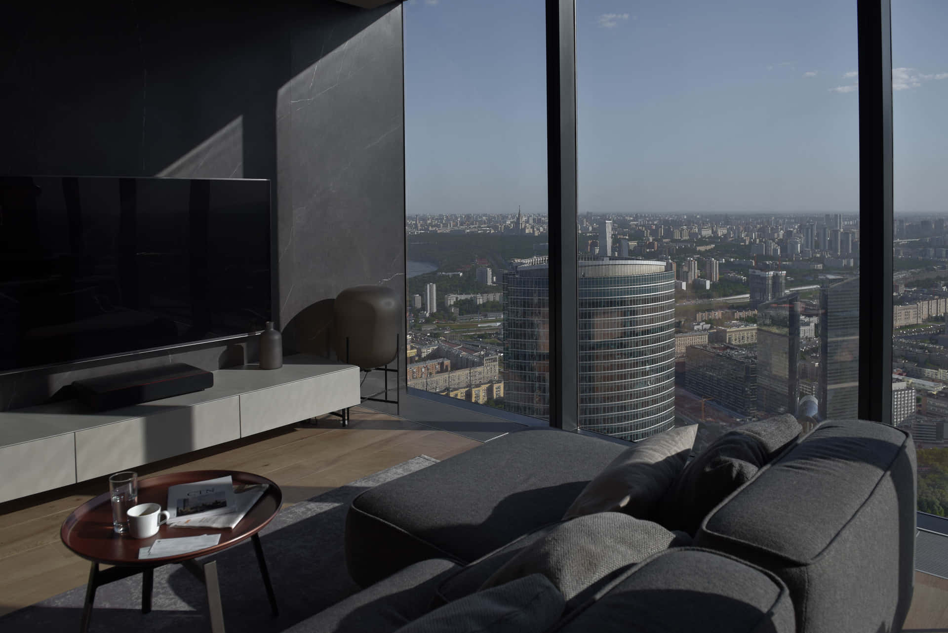 A Living Room With A Large Window Overlooking A City Wallpaper