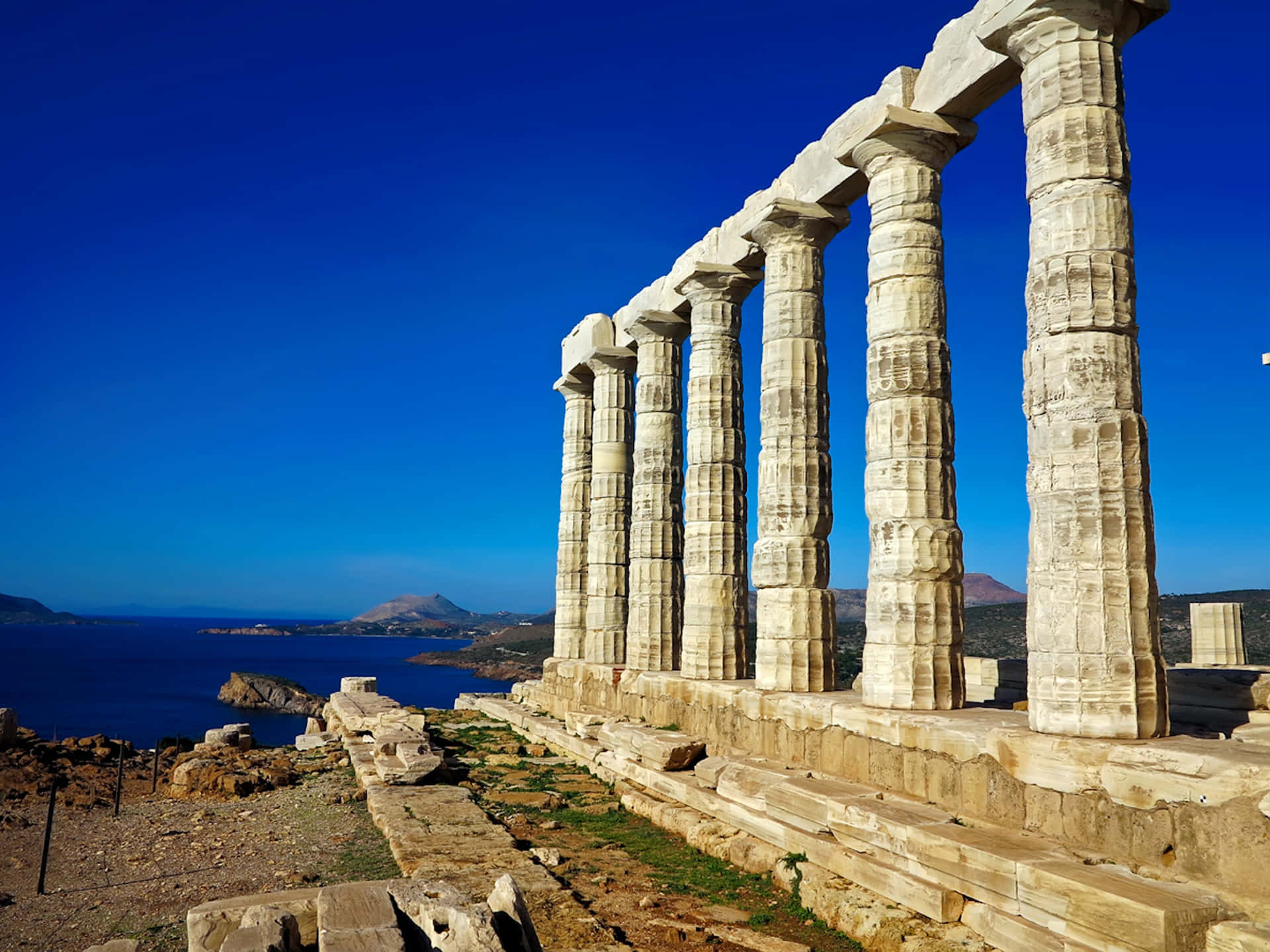 Caption: Majestic view of the Temple of Poseidon at Cape Sounion. Wallpaper