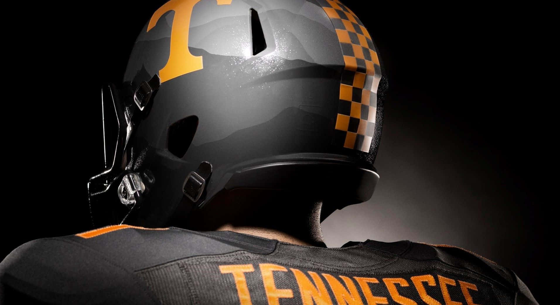 Tennessee Football Helmet With A Black And Orange Design Wallpaper