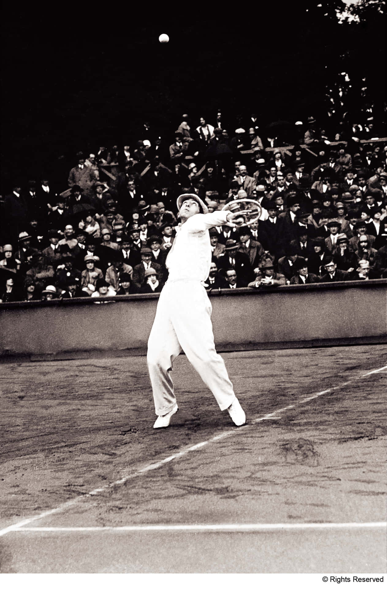 René Lacoste gracefully performing an overhead tennis shot. Wallpaper