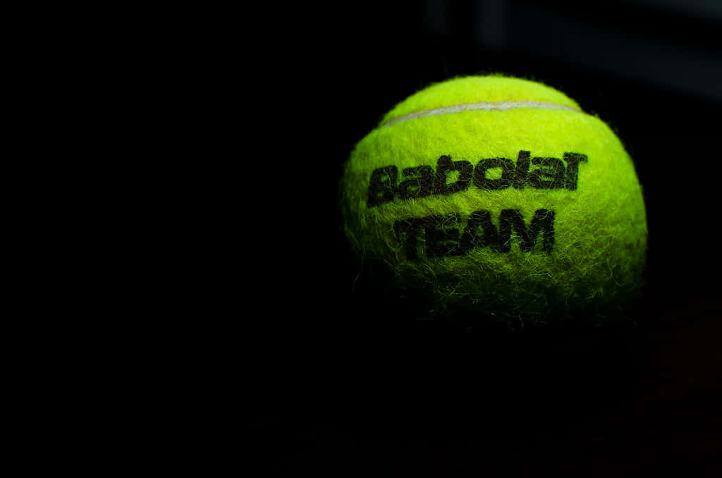 A Tennis Ball With The Word Baboler Team On It Wallpaper