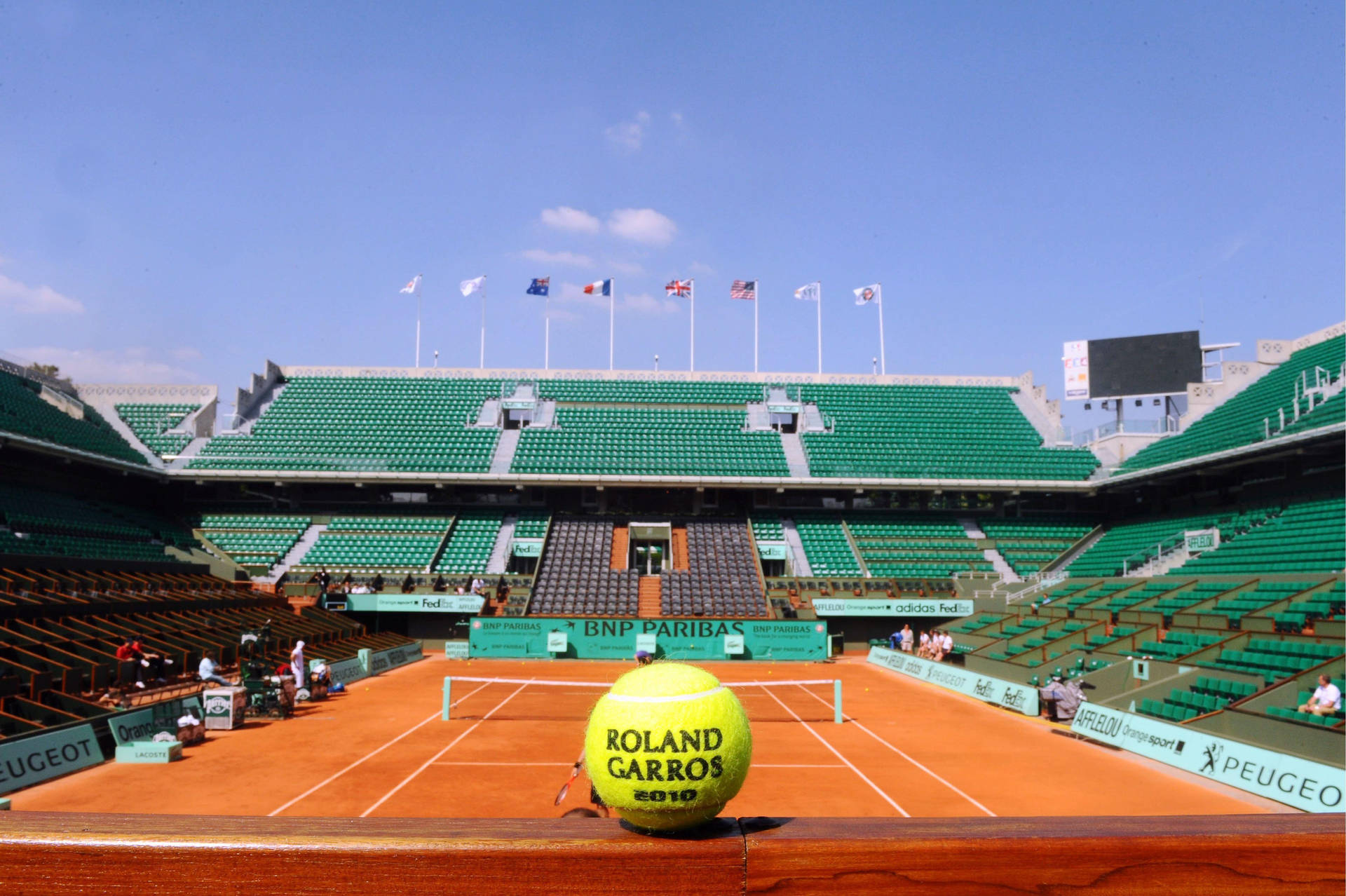 Tennis Ball Against French Open Court Wallpaper