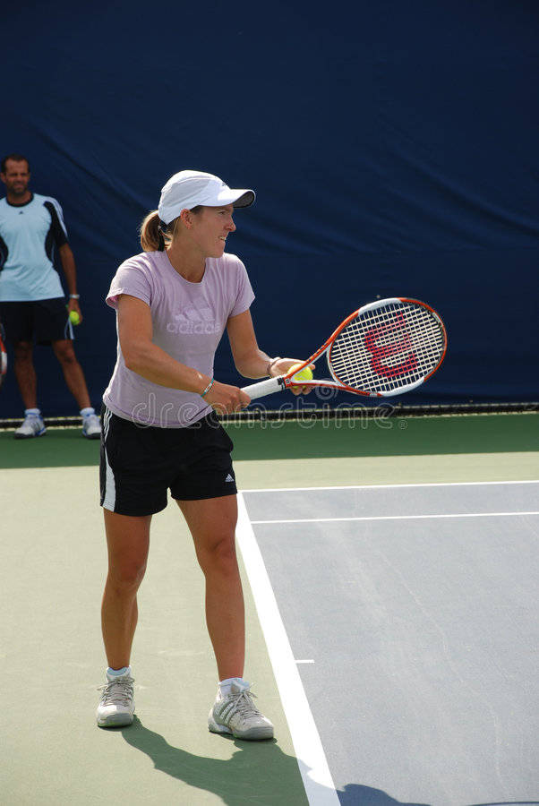 Justine Henin Showing Remarkable Skills on Tennis Court Wallpaper