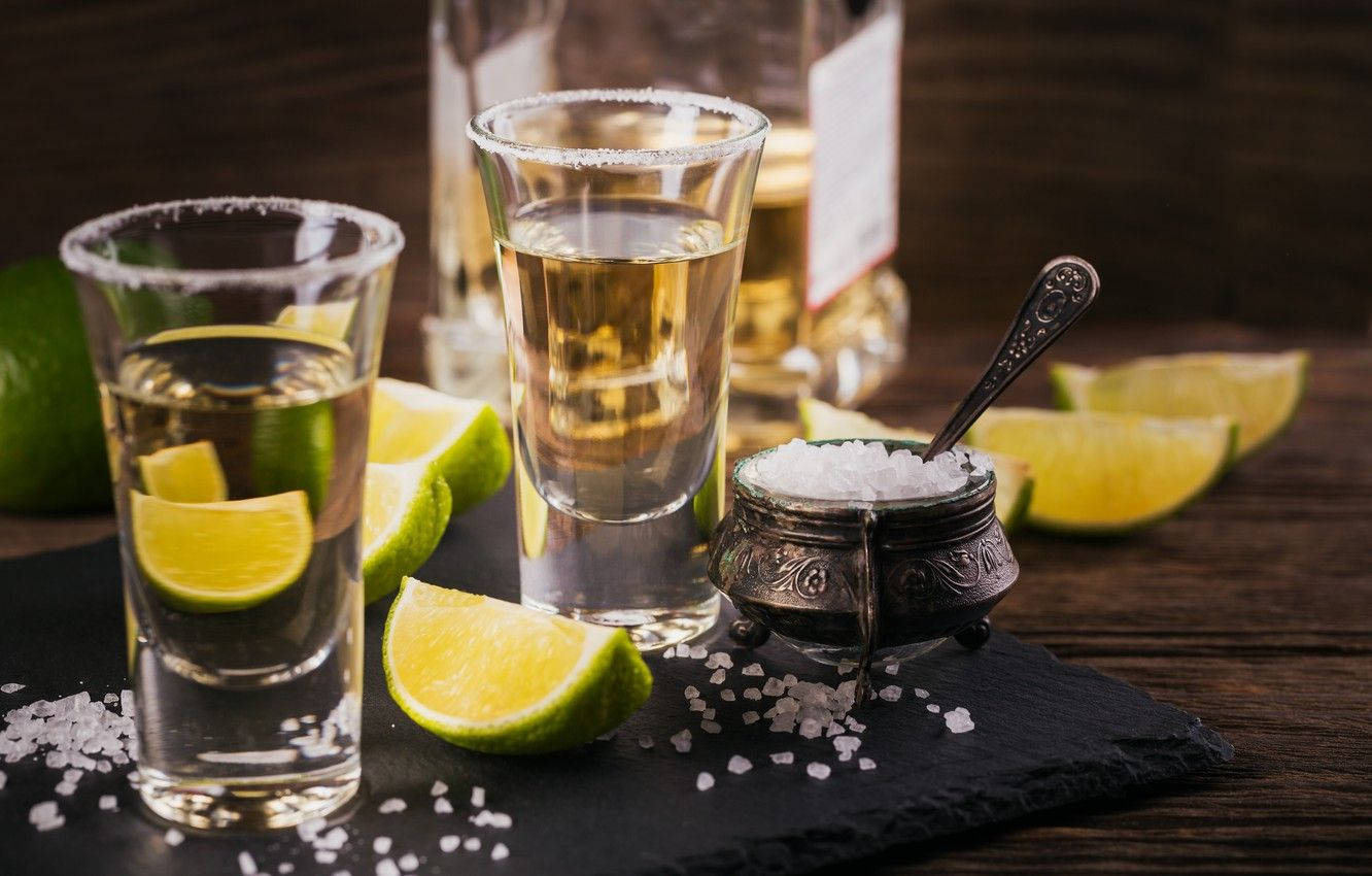 Tequila On Shot Glasses With Lime Slices Wallpaper