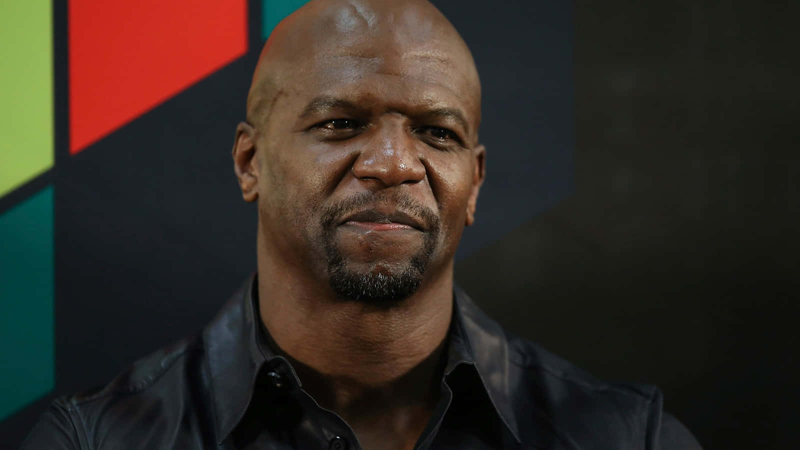 American Actor, Terry Crews, flexing muscles and smiling at the camera Wallpaper