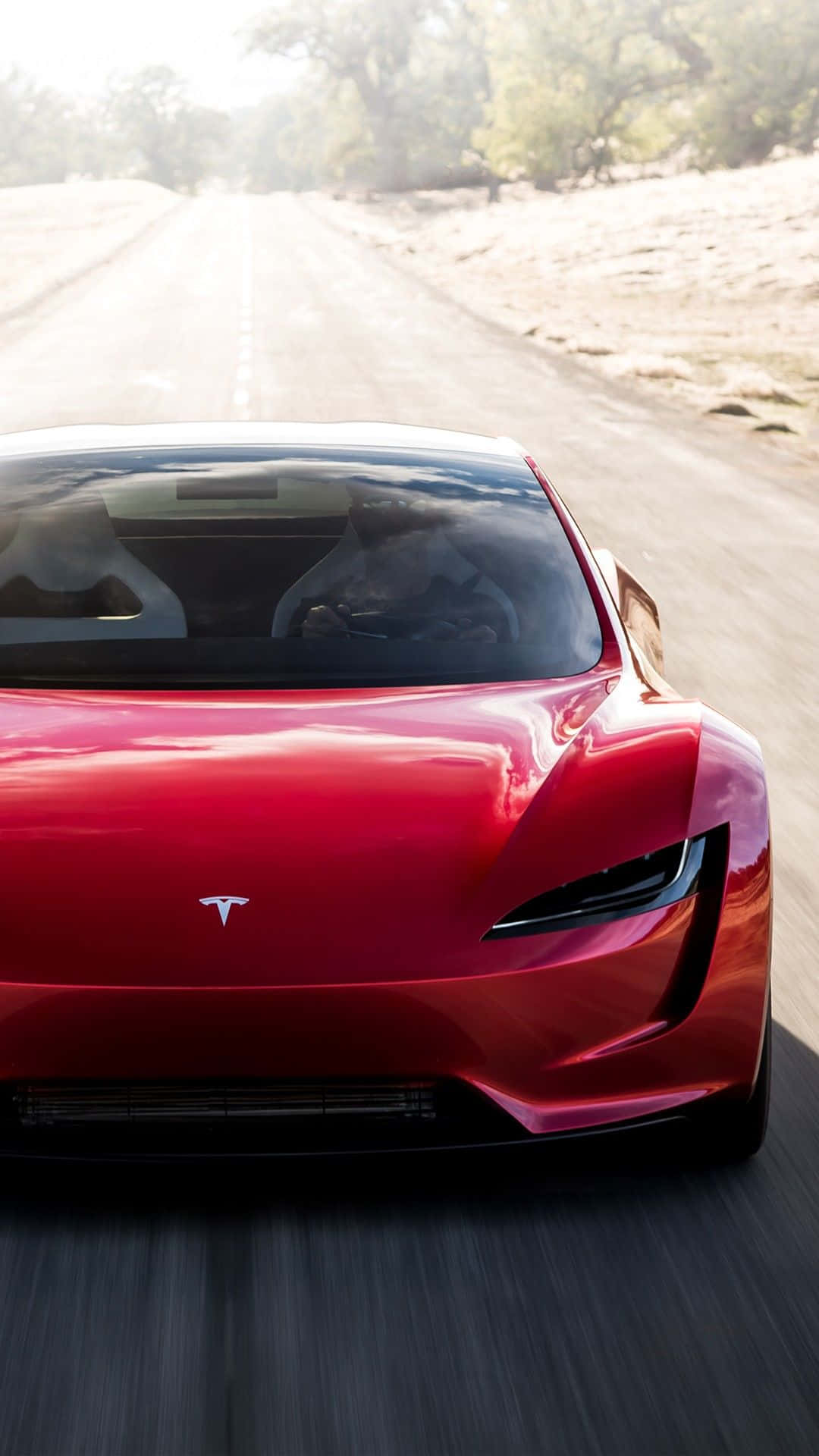 Teslas Roadster iPhone baggrund: En billedbaggrund, der viser en Tesla Roadster. Wallpaper