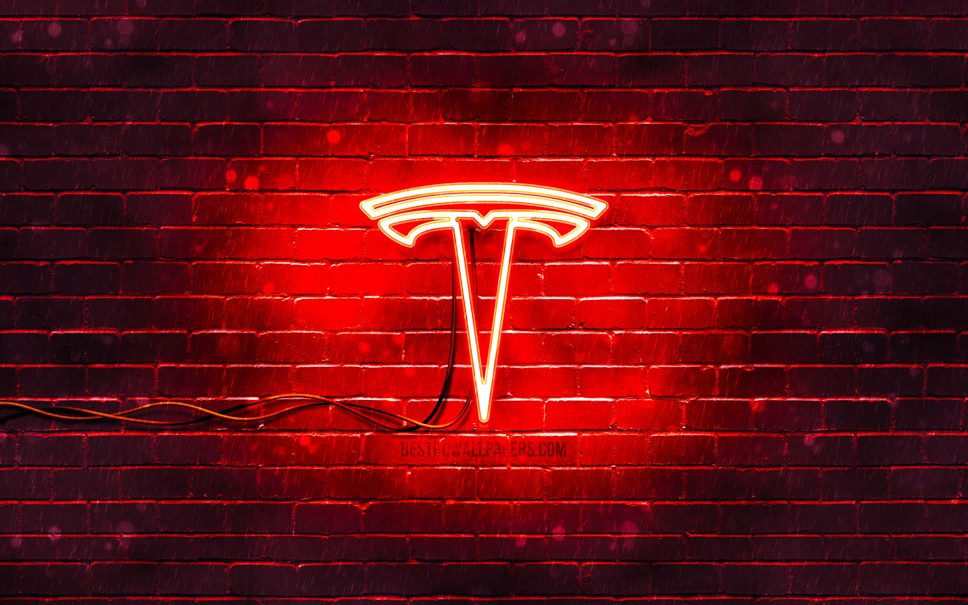 A Red Tesla Sign On A Brick Wall Wallpaper