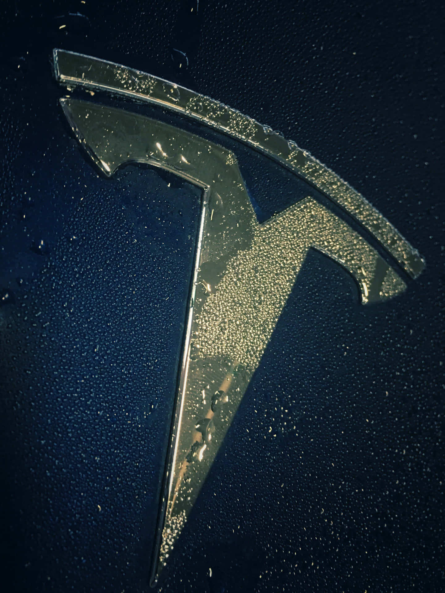 Image  A sleek Tesla logo with illuminated lightning bolts in 4K resolution Wallpaper