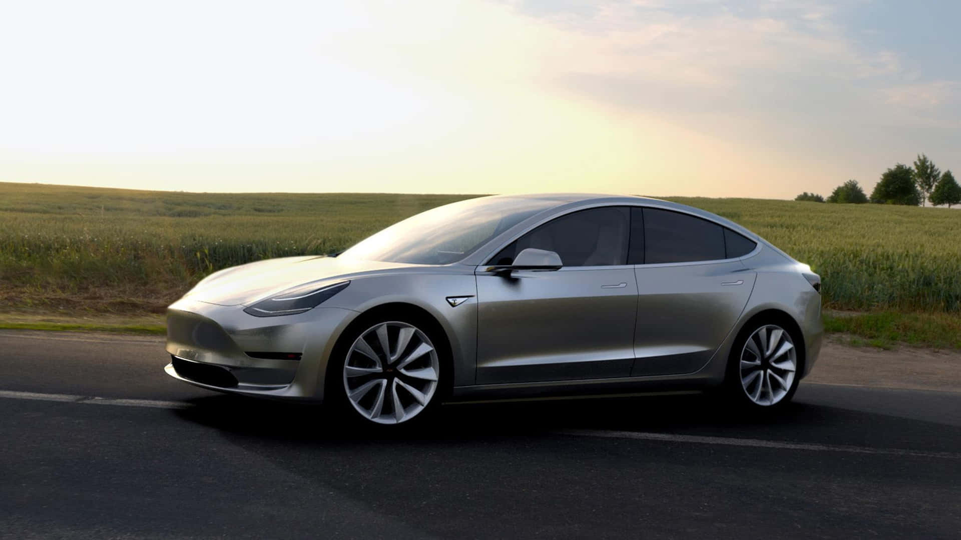 Teslamodel 3 - En Silverbil Som Kör Längs En Väg