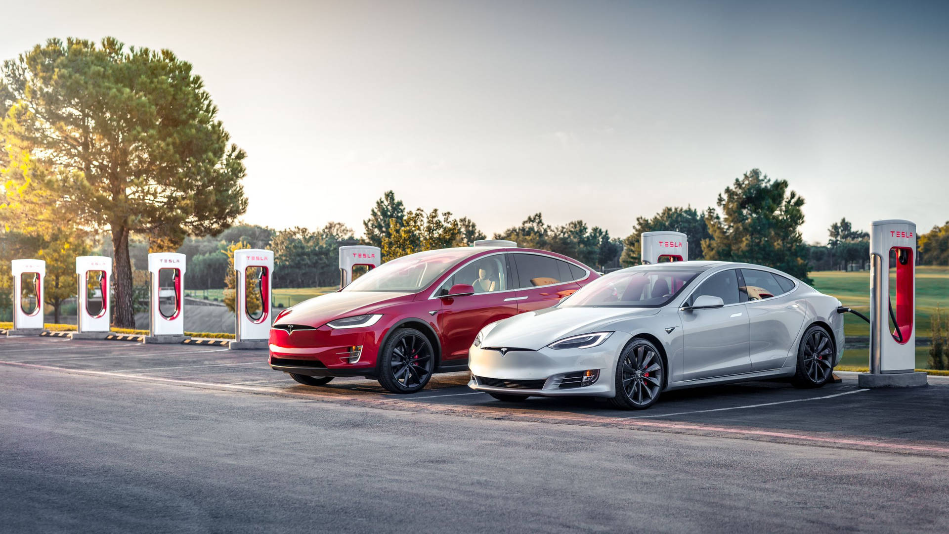 Tesla Models X and 3 - Emblems of Sustainability and Innovation Wallpaper