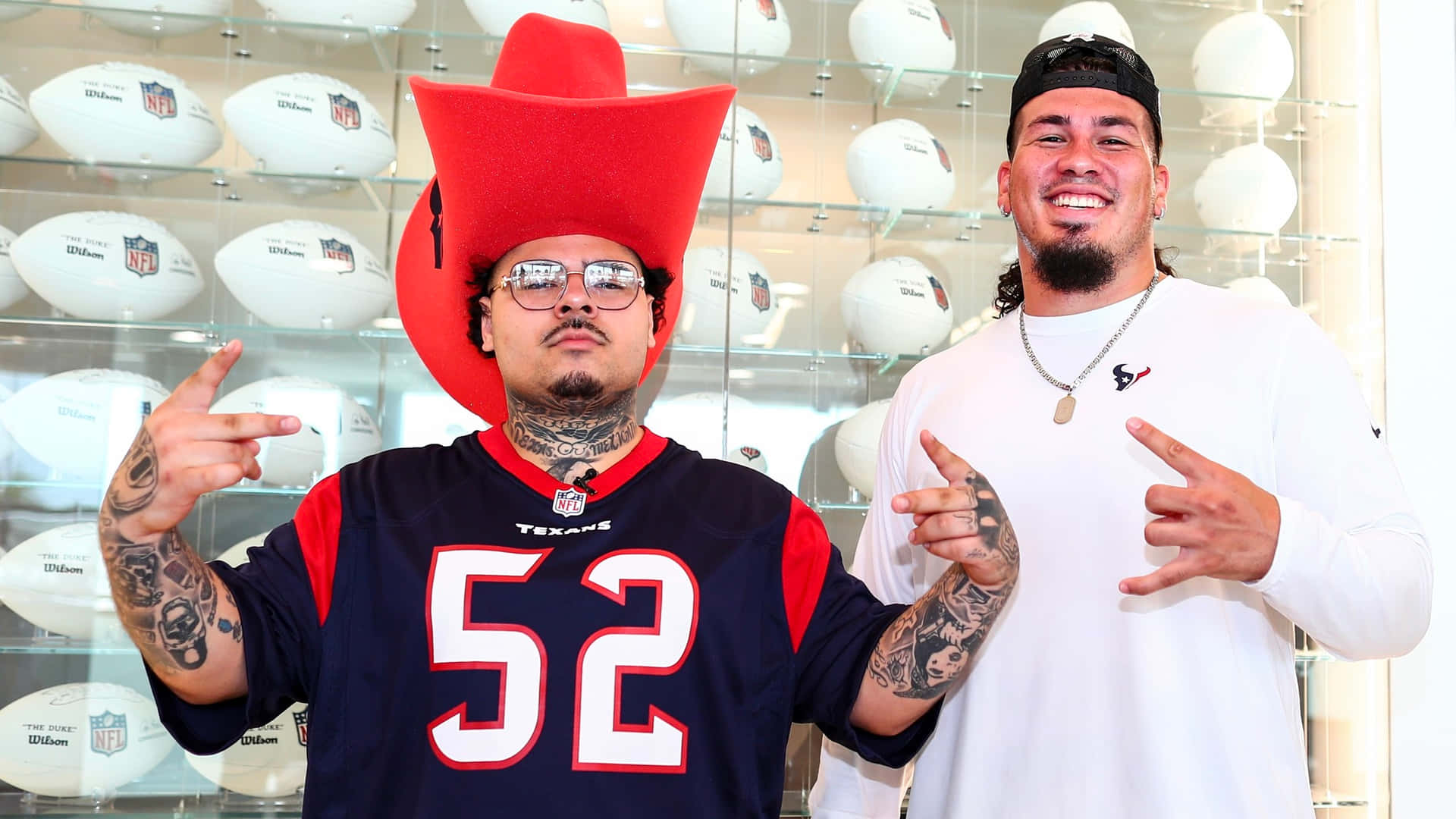 Texans Fans Posing With Footballs Wallpaper