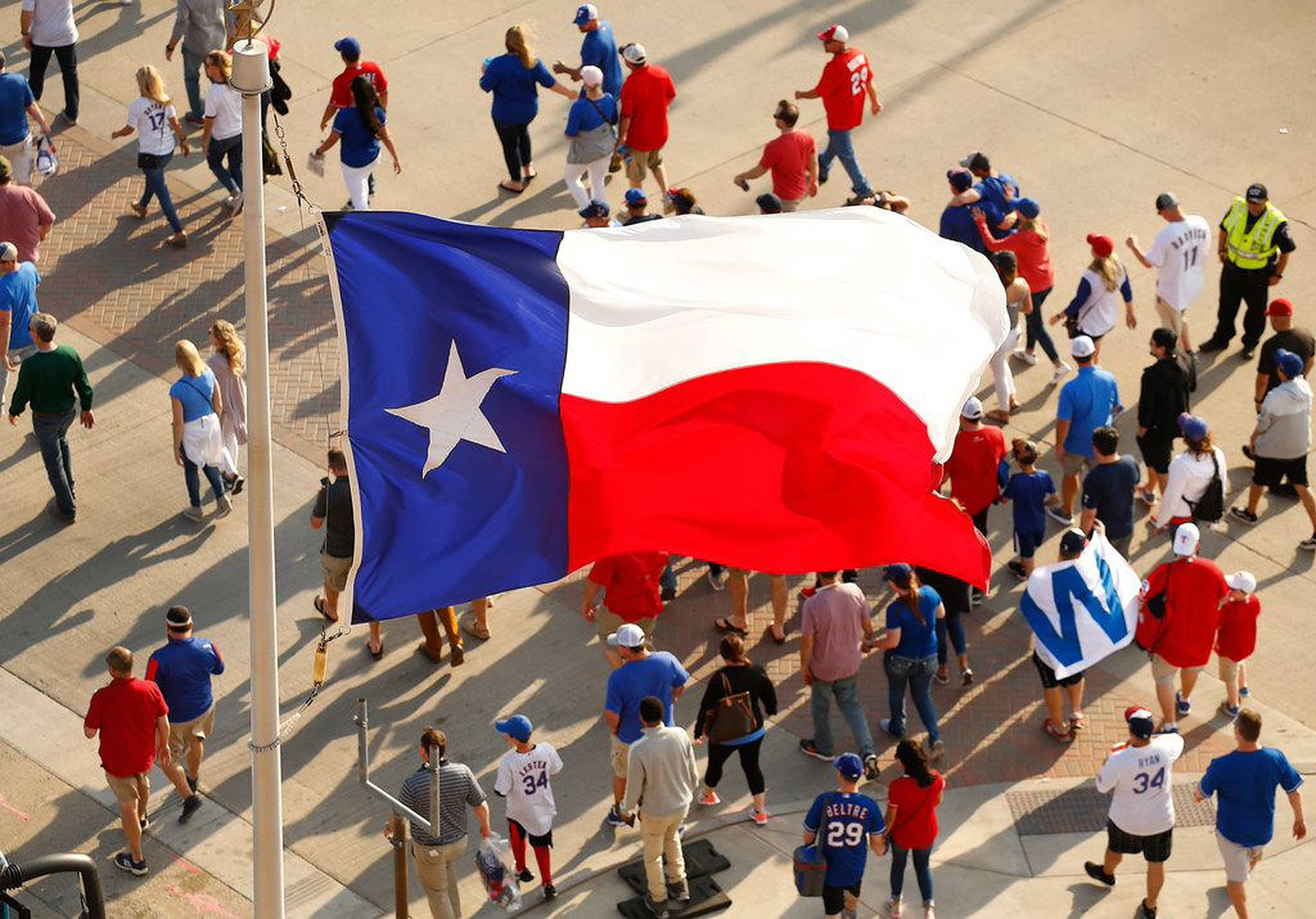 Patriotic Crowd in Front of Texas Flag Wallpaper