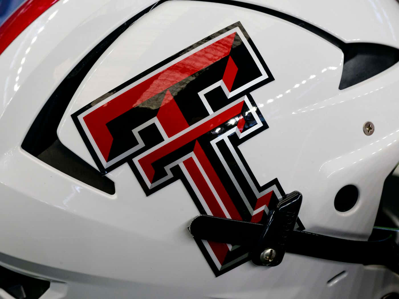 A Close Up Of A White Helmet With A Red And Black Logo Wallpaper