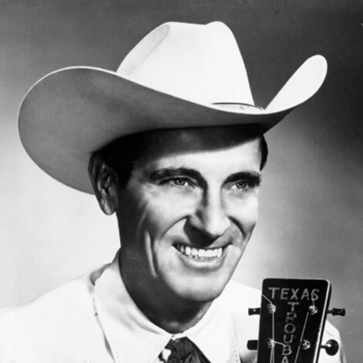 The Texas Troubadour, Ernest Tubb strumming his guitar Wallpaper