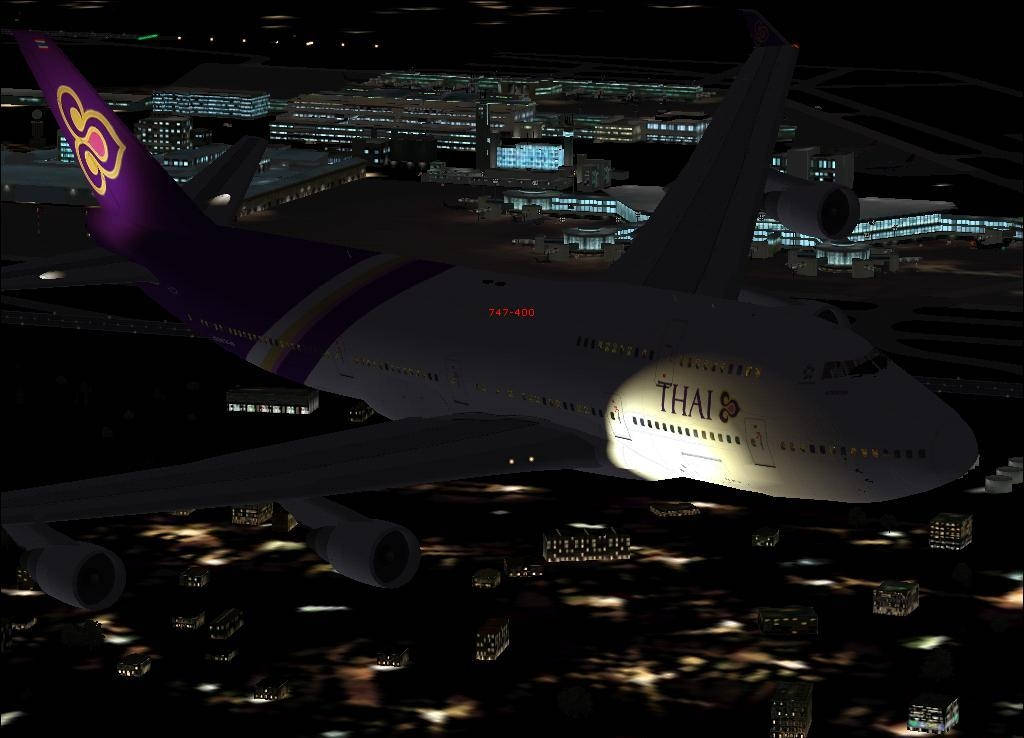 Download Thai Airways Airplane With City Buildings Wallpaper | Wallpapers .com