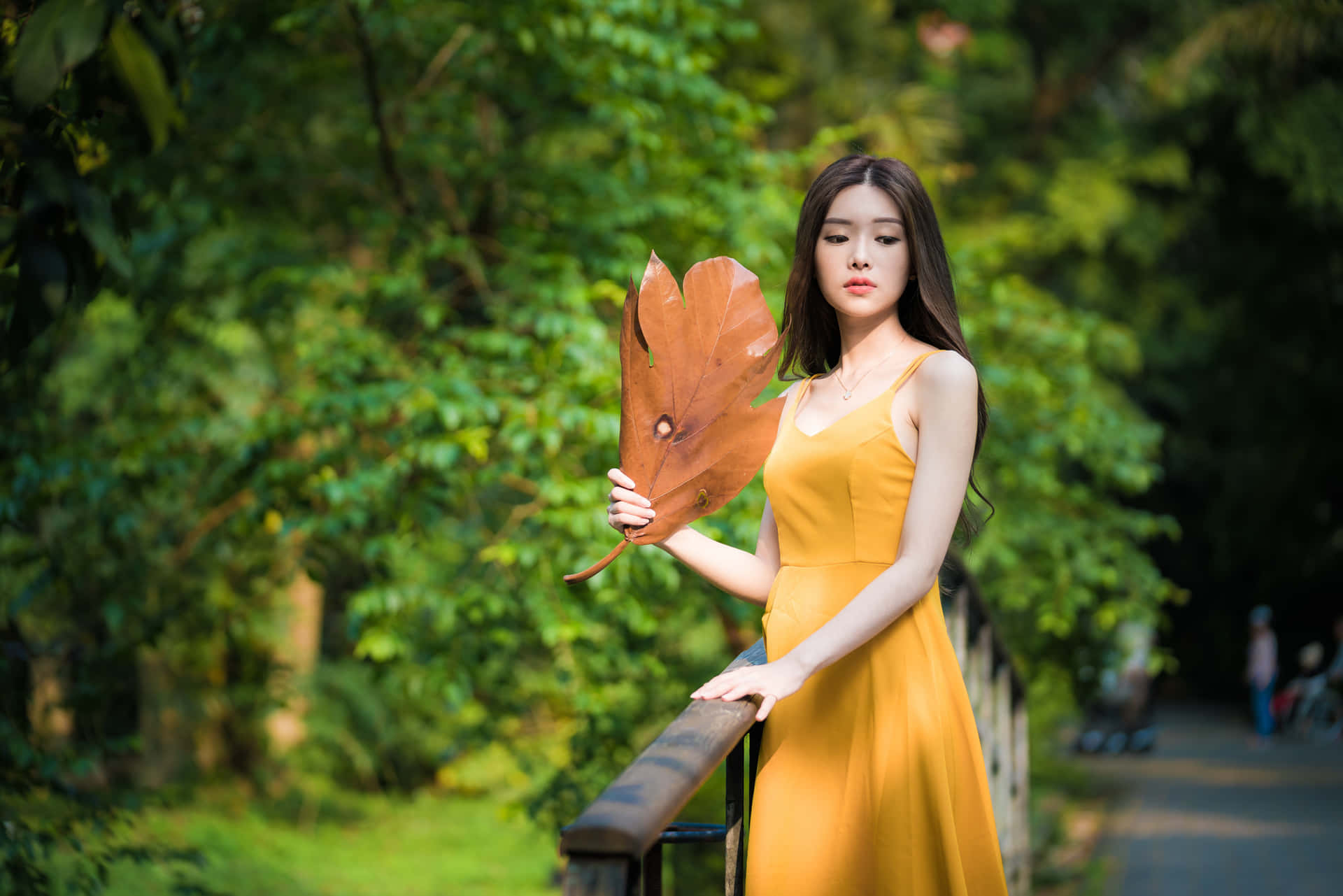 Thai Girl Posing With Large Leaf Wallpaper