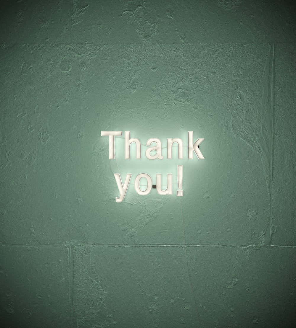 A Neon Sign That Says Thank You On A Wall
