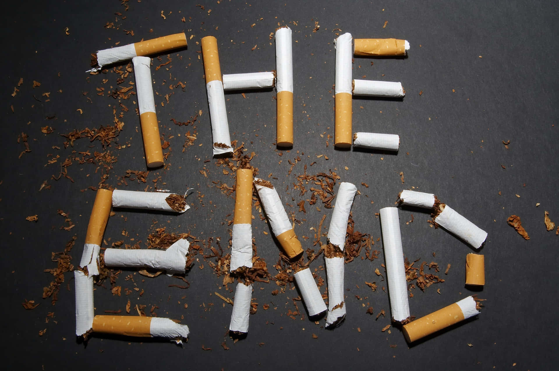 The End Of Cigarettes Spelled Out On A Black Background Wallpaper