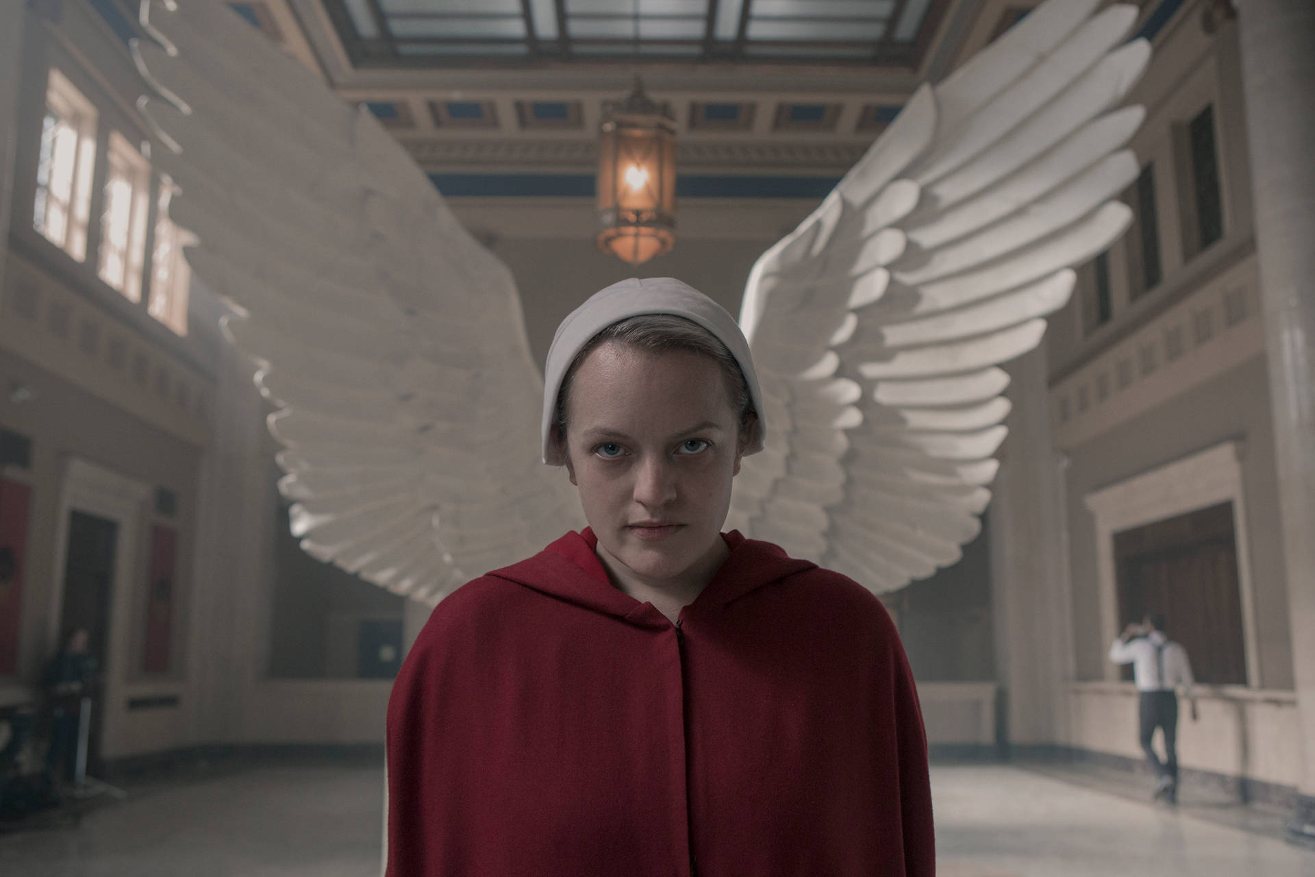 The Handmaid's Tale June Against Statue Of Wings Background