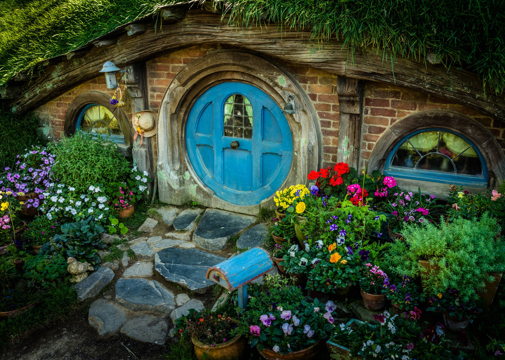 Caption: Enchanting Hobbit House nestled in the heart of New Zealand's countryside Wallpaper