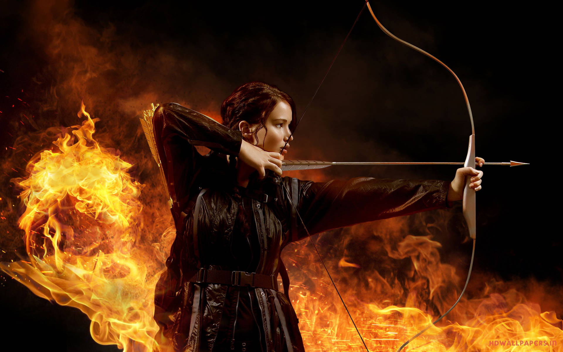 Katniss Everdeen from The Hunger Games Series Aiming with Bow Wallpaper